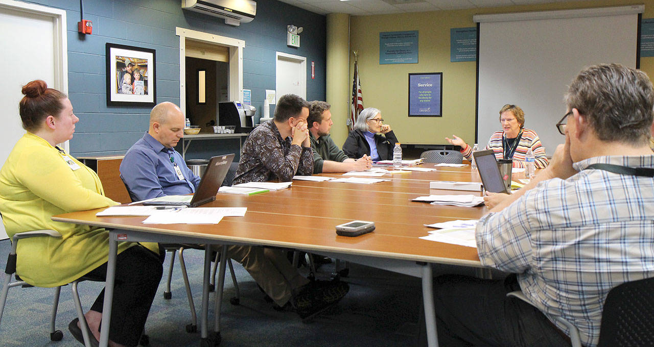 Members of the Timberland Regional Library’s Facilities Committee meet with TRL staff Wednesday, Oct. 3, 2018, at TRL offices in Tumwater. Corby Varness, second from right, expressed frustration at the way a Capitol Facilities Proposal had been made public during the meeting.