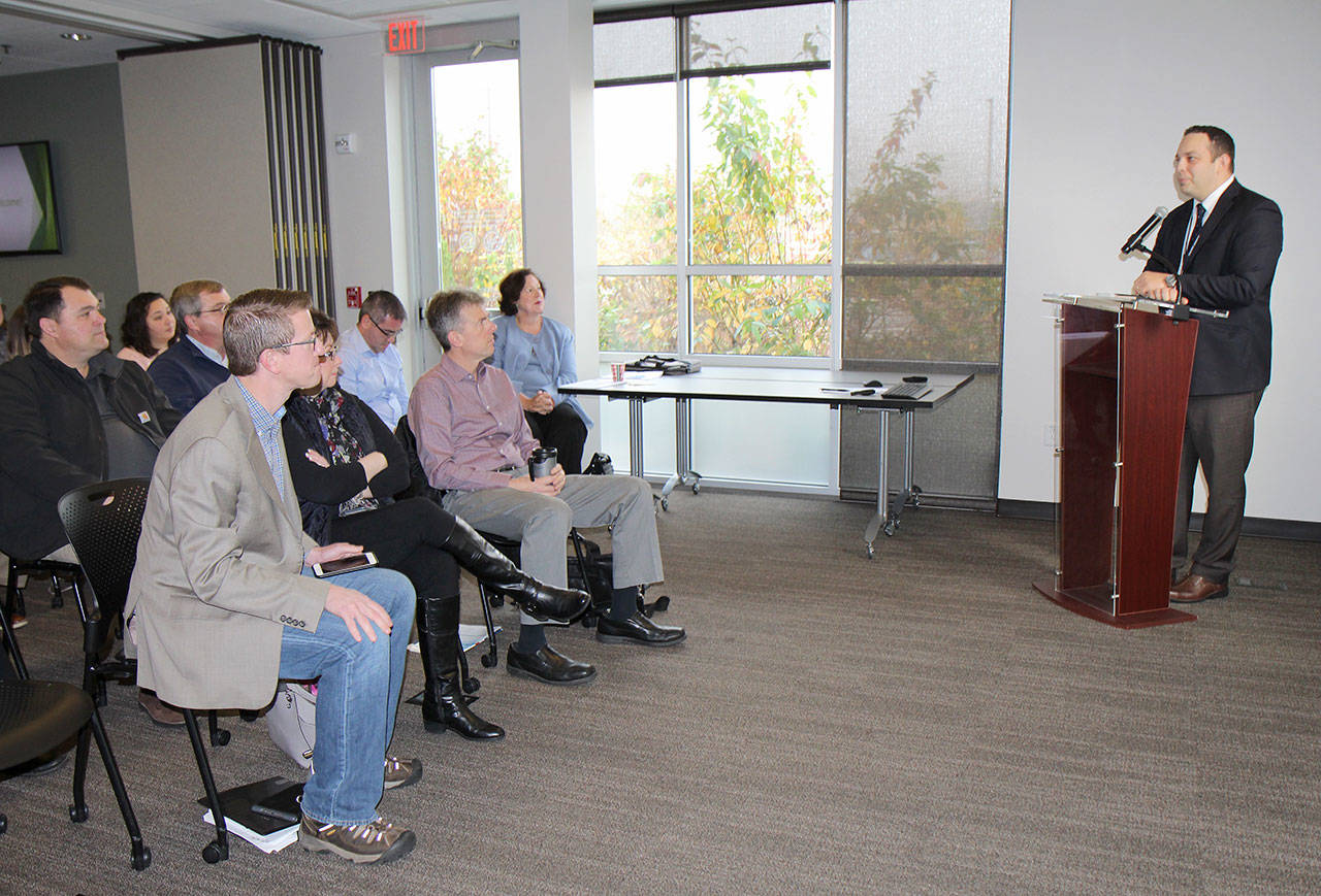 Summit Pacific Medical Center CEO Josh Martin, right, introduces Rep. Derek Kilmer, seated in front row at left, Monday Dec. 3, 2018, at the Economic Development and Grants Seminar at the hospital in Elma. About 40 people attended the seminar, including county, Elma and Montesano officials.