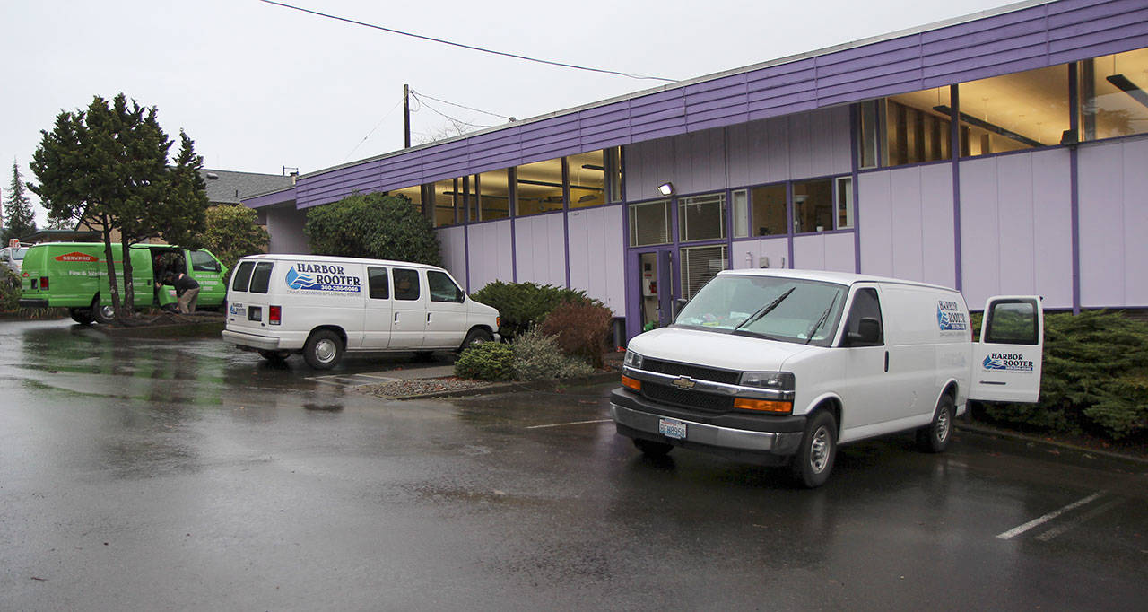 Harbor Rooter and ServPro vans sit Dec. 13 outside the W.H. Abel Library in Montesano after flooding forced closure of the building.