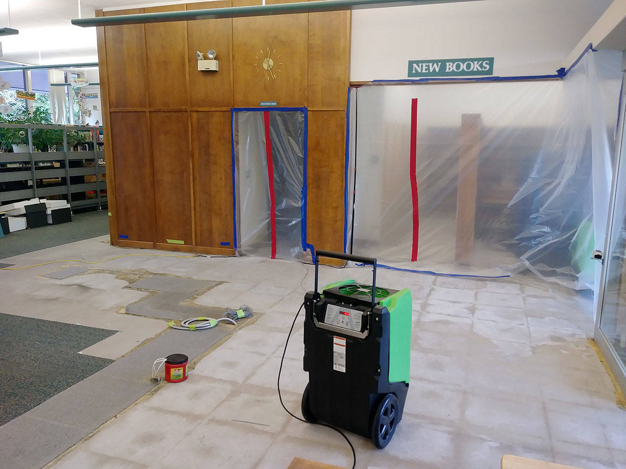 Plastic sheeting blocks off portions of the main floor of the Montesano library Friday, Dec. 15, 2018, in Montesano, Washington. Flooding Dec. 11 damaged wall boards, carpeting and the main entryway desk. Because of asbestos abatement and other repair work that needs to be done, the Timberland Regional Library system, which owns the building, does not know when the building will be reopened.
