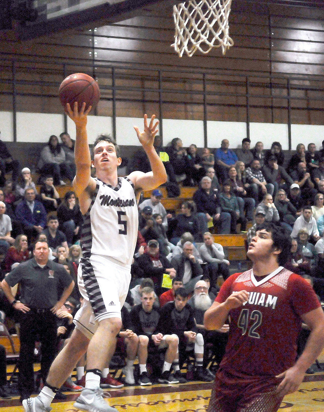 Montesano’s Evan Bates hits layup in the first quarter against Hoquiam on Friday. Bates led the Bulldogs with 24 points in Montesano’s 69-47 win on Friday. (Hasani Grayson | Grays Harbor News Group)