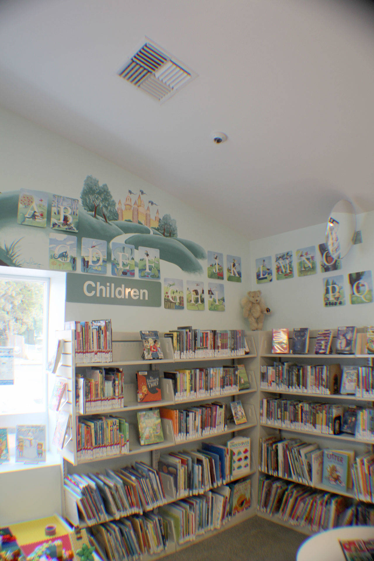 A camera (top center) overlooks the childrens section of the McCleary Timberland Regional Library on Saturday, Jan. 19, 2019 in McCleary. The branch will become a test site for the Open Plus system, which allows patrons to access the library and use its services during expanded hours when it would otherwise be closed. The one-year trial of the service is set to begin Feb. 1. (Michael Lang | Grays Harbor News Group)