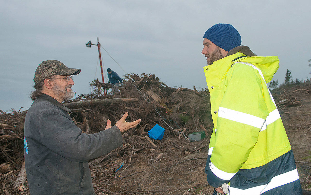 MARCY MERRILL PHOTO                                Pacific County Drainage District #1 commissioner David Cottrell, left, speaks with Paul Bayle, a researcher from the University of Bath in England in North Cove Wednesday. Bayle is researching dynamic revetment and is placing a lidar tower along the beach to track the work being done by locals to preserve the shoreline.