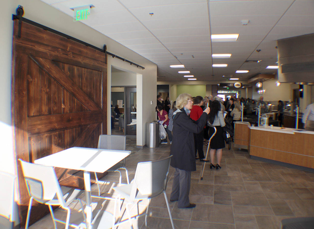 Tyler Thompson of Elma’s Rusty Tractor created this barn door (left) for use in the Summit Pacific Wellness Center’s dining area. The Rusty Tractor is across the street from the Wellness Center. Photo taken during a celebration of the building’s completion on Jan. 25, 2019, in Elma, Washington. Michael Lang | Grays Harbor News Group