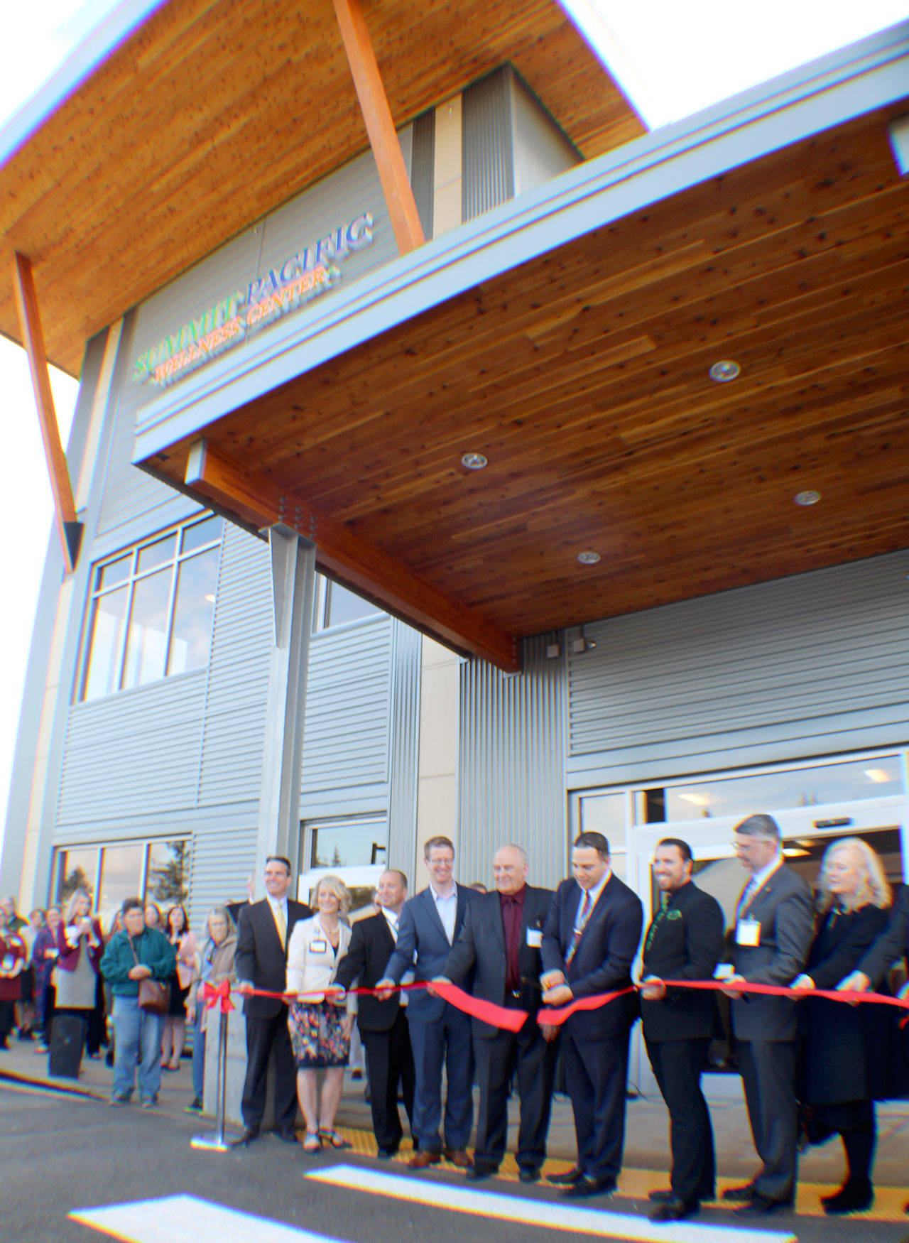 Summit Pacific CEO Josh Martin (fourth from right) cuts the ceremonial ribbon to open the Wellness Center on Jan. 25, 2019, in Elma, Washington. Hospital executives and local dignitaries, including Rep. Derek Kilmer (D-Gig Harbor, sixth from right), joined Martin for the ceremony. Michael Lang | Grays Harbor News Group