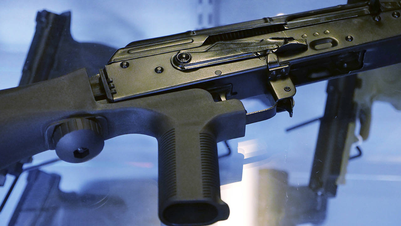 A device called a “bump stock” is attached to a semi-automatic rifle Oct. 4, 2017, at the Gun Vault store and shooting range in South Jordan, Utah. A federal ban, sought by the Trump administration, takes effect in March. (AP Photo/Rick Bowmer)