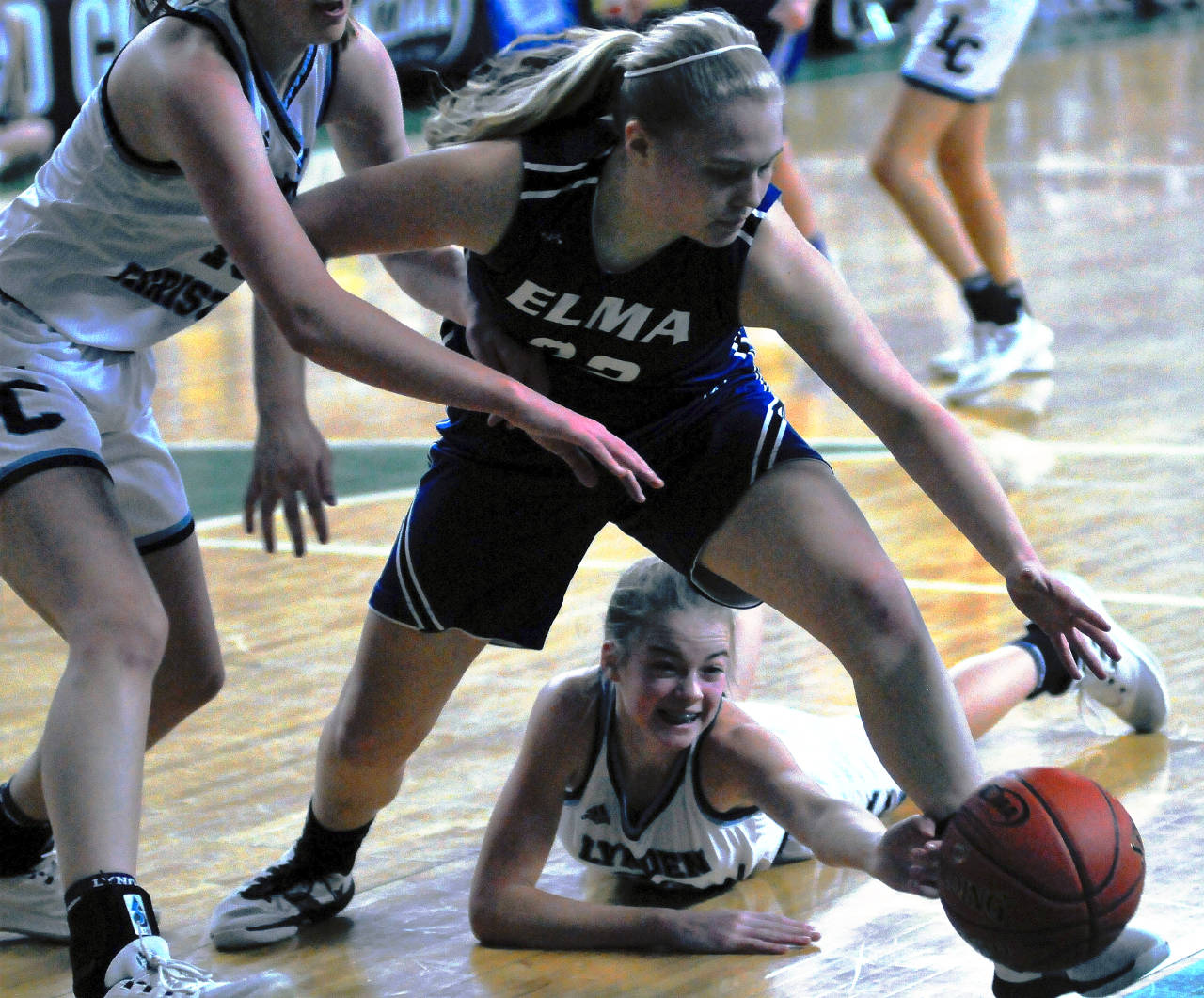 Elma’s Quin Mikel battles for a loose ball in the first quarter against Lynden Christian. Mikel led the Eagles with eight points in a 55-25 loss on Thursday in the 1A State Tournament. (Hasani Grayson | Gray Harbor News Group)