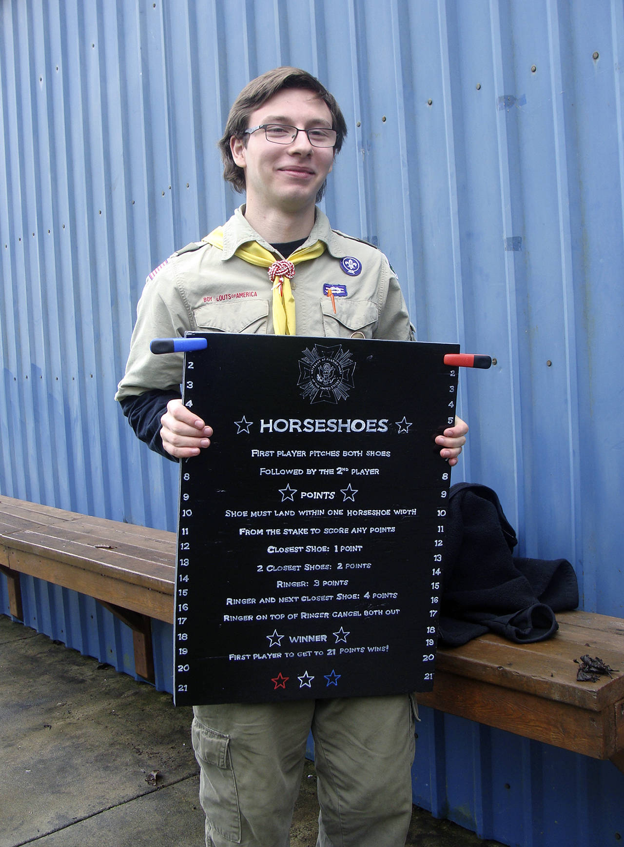 (Photo courtesy Malchert family) Daniel Malchert holds a scoring tablet that’s now posted at the horseshoe pits he built at VFW Memorial Park in Montesano.