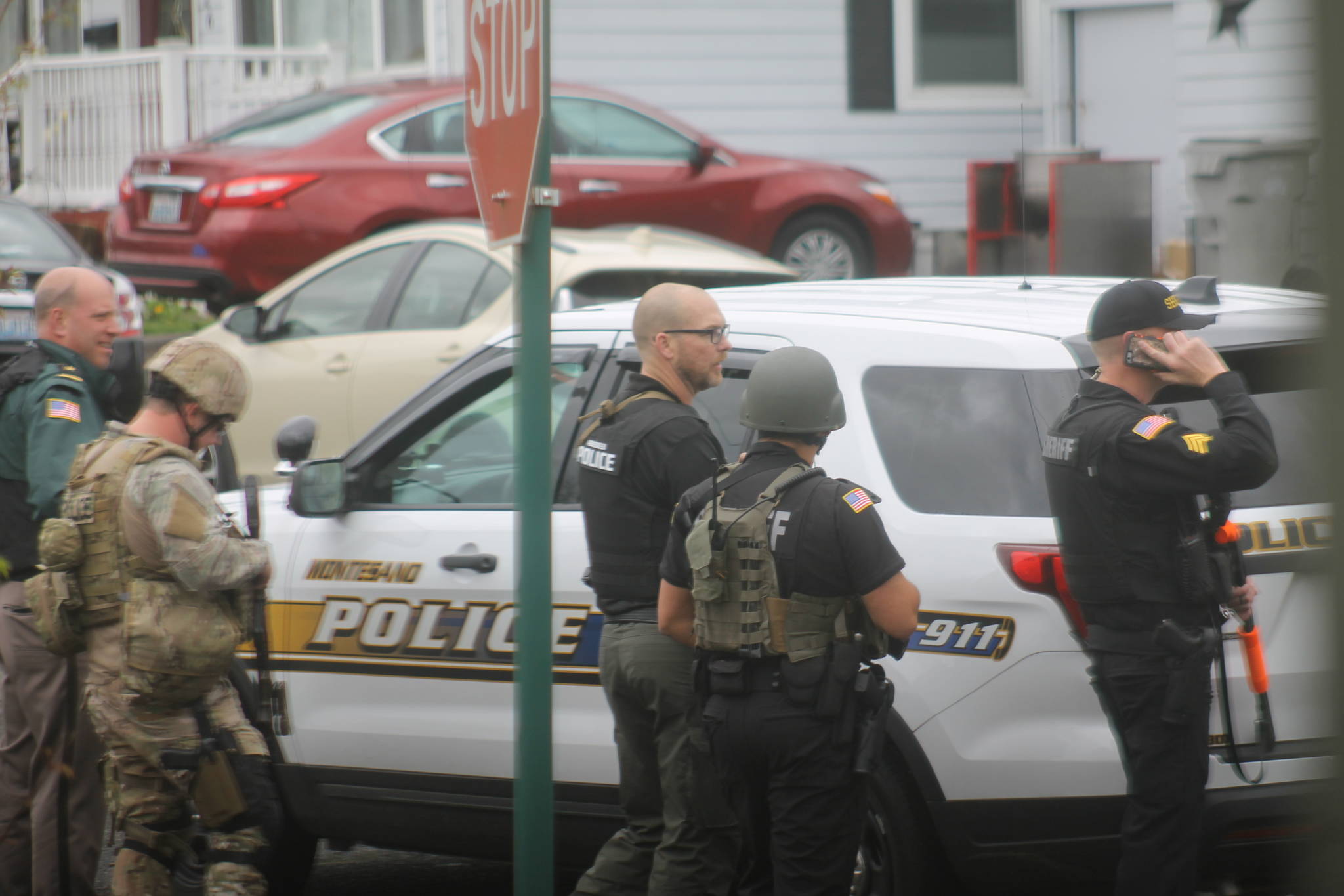 Officers from several different departments respond to a standoff situation Tuesday at a home on Academy Street in Montesano. One man, who officers say charged at them with swords, was shot and taken to Grays Harbor Community Hospital with what were described in the police statement as life-threatening injuries. (Josh Jessen photo)