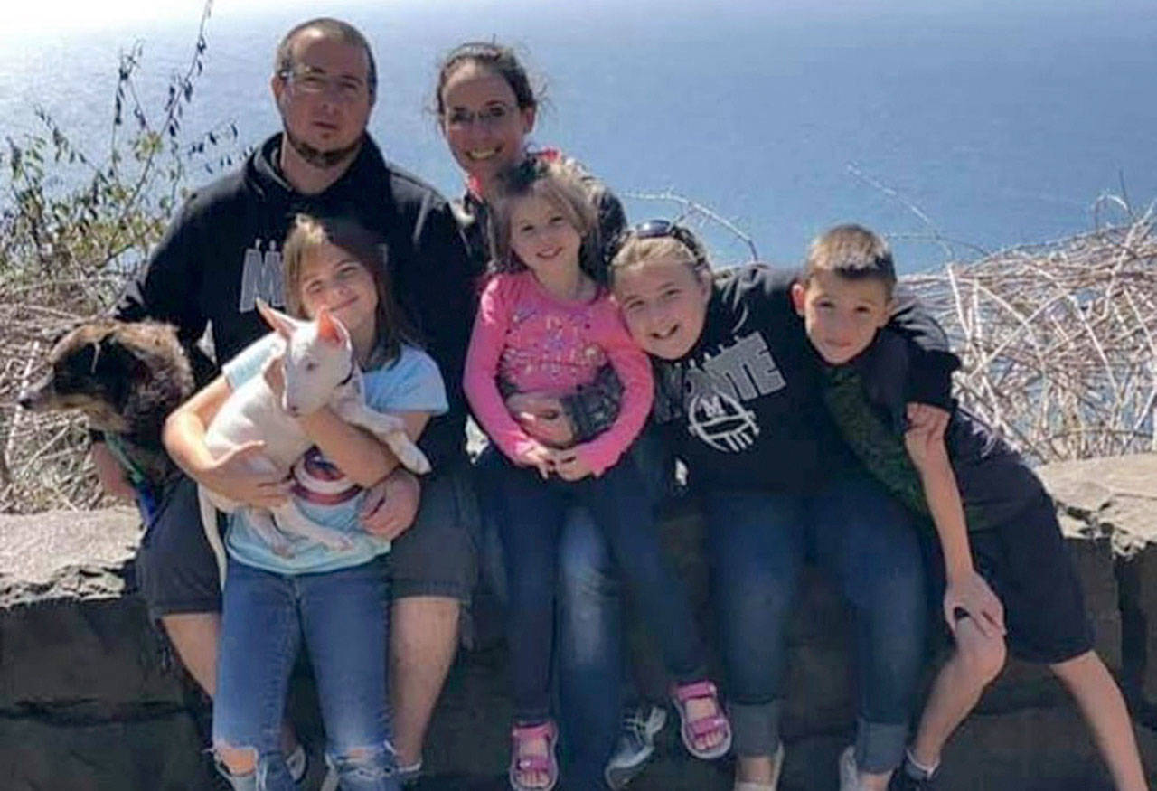 Sara and Thomas Johnson, back row from left, pose for a picture with their four children and two dogs. (Photo courtesy Sara Johnson)