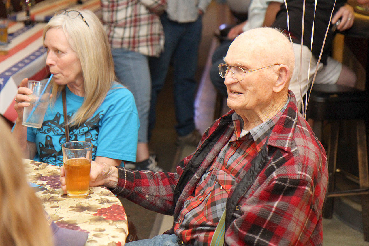 Grant Edwards (right) of Aberdeen enjoys a beer Saturday, May 4, during his 100th birthday celebration at the Veterans of Foreign Wars post in Montesano, where Edwards is a lifetime member. Edwards was born May 3, 1919, in Great Falls, Montana. He enlisted in the U.S. Navy on Dec. 11, 1939. During his 20-year Navy career, Edwards was stationed in San Diego, where he was in Hospital Corps School; Bremerton; aboard the USS Hendry attack transport; Aberdeen; Camp Pendleton, California; and in El Toro, California. He transferred to the Navy Reserve on Aug. 1, 1960.