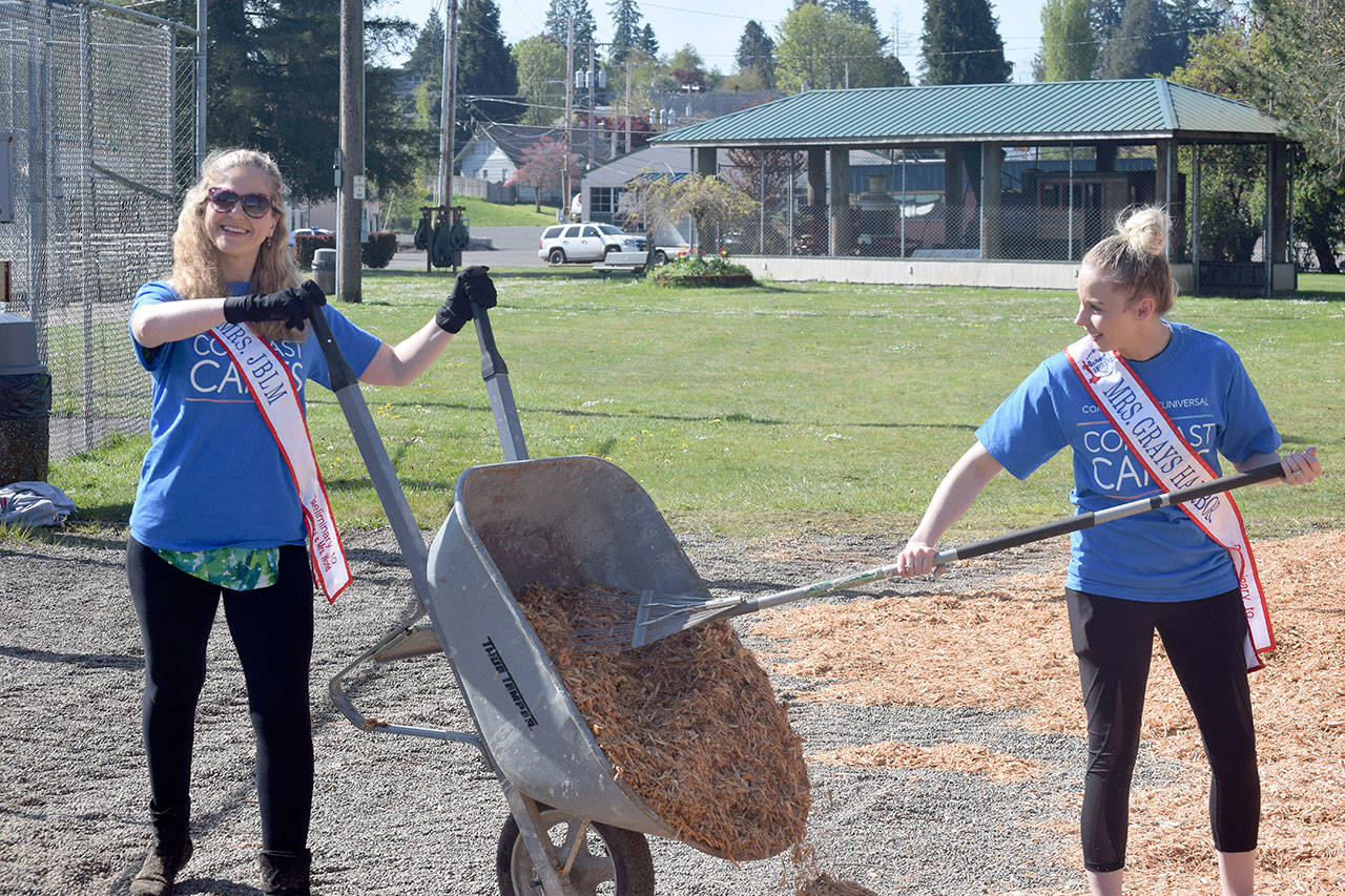 Volunteers Mindy Dunn (left) and Brandi Jo Ross spread wood chips May 4 at McCleary’s Beerbower Park. The women were taking part in Comcast Corp.’s Comcast Cares Day. (Photo courtesy Comcast Corp.)