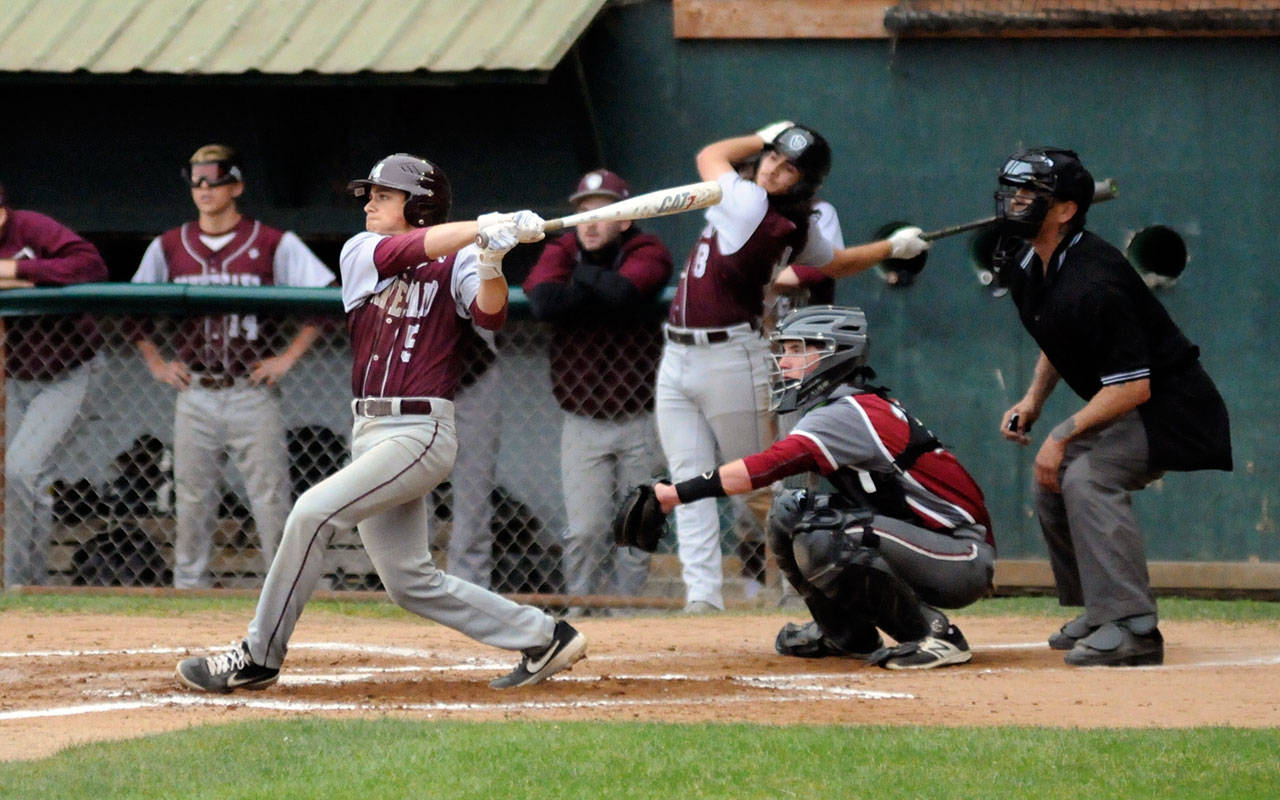 Montesano’s Aaron Lano, left, belts a base hit against the Hoquiam Grizzlies on Saturday. Lano was one of four Bulldogs to collect two hits in the game. (Ryan Sparks | Grays Harbor News Group)