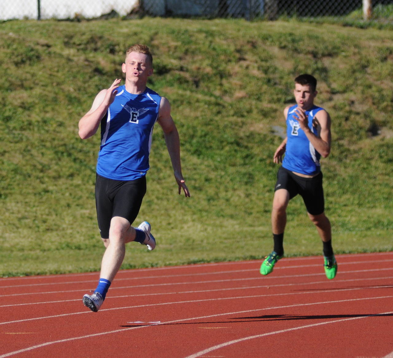 Elma’s Cody Vollan, left, races around the final corner of the boys 400 meters during the 1A Evergreen League Championship meet in Montesano. Vollan won the event with teammate Ray Billerback, right, placing second. (Ryan Sparks | Grays Harbor News Group)
