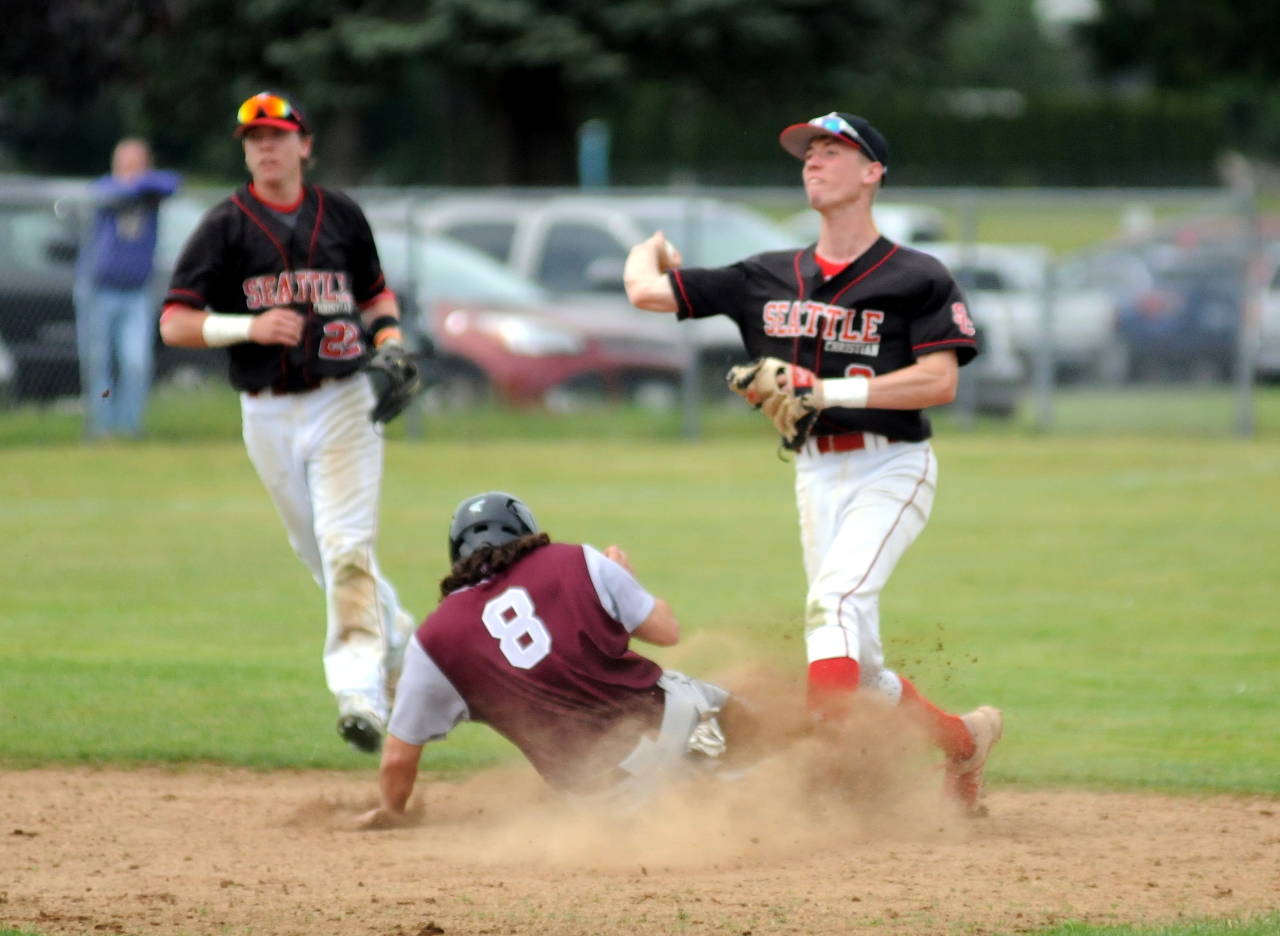 Montesano’s Teegan Zillyett (8) slides into second base as Seattle Christian infielder Connor Knack makes a throw to complete a double play during Saturday’s 1A regional final in Castle Rock. (Ryan Sparks | Grays Harbor News Group)