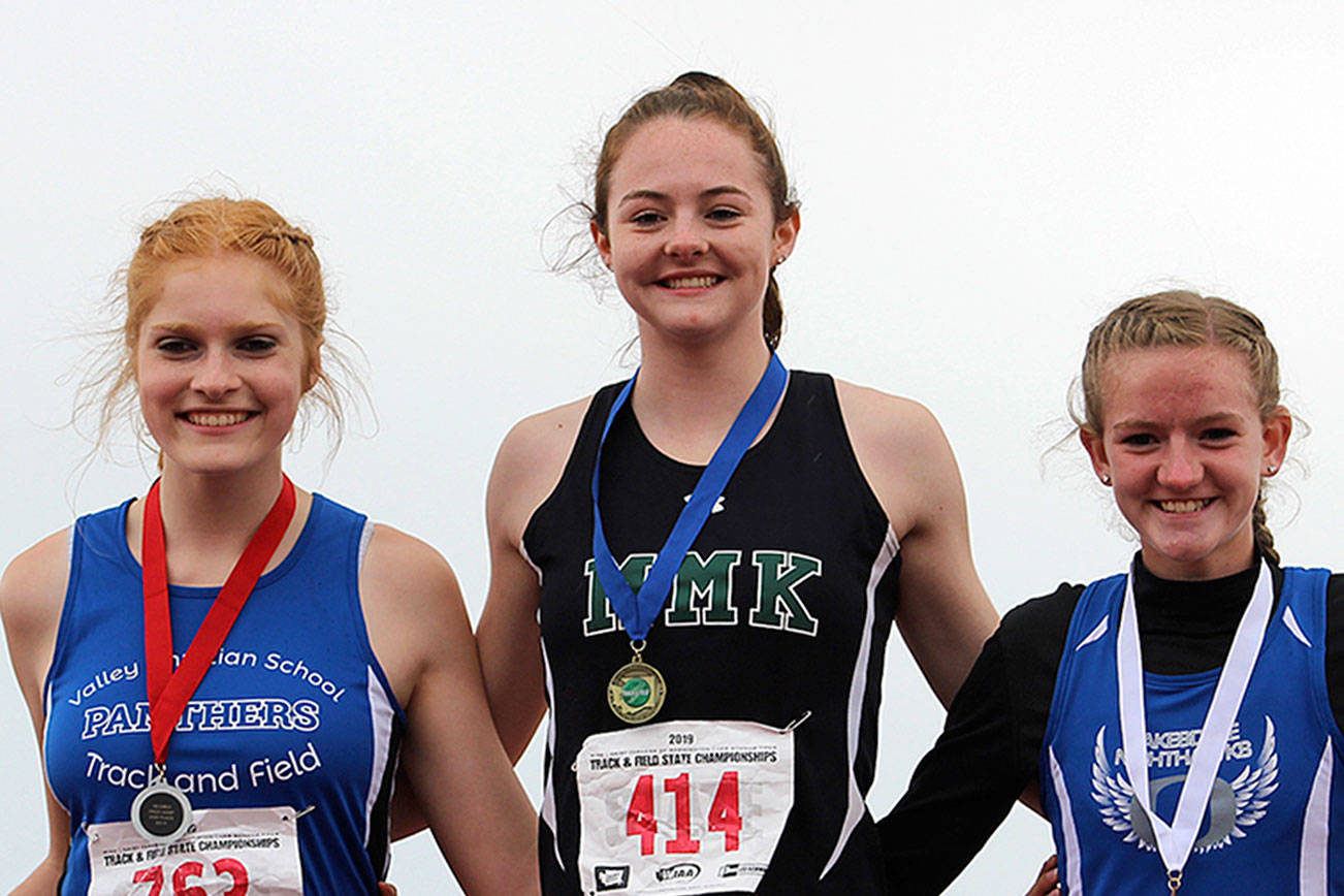 Mary M. Knight senior Kaylee Sowle (center) won the 1B state championship in high jump for the second consecutive year Friday in Cheney Friday. She tied her own 1B meet record, clearing 5 feet, 8 inches. WIAA officials also commended her for sportsmanship after learning that while competing in her event she took time to assist a rival competitor who had some difficulties. Sowle is flanked by Valley Christian’s Julia Hayes (left), who finished second, and Oakesdale’s Bree Rawls, who finished third. (Photo courtesy Patrick Webb)