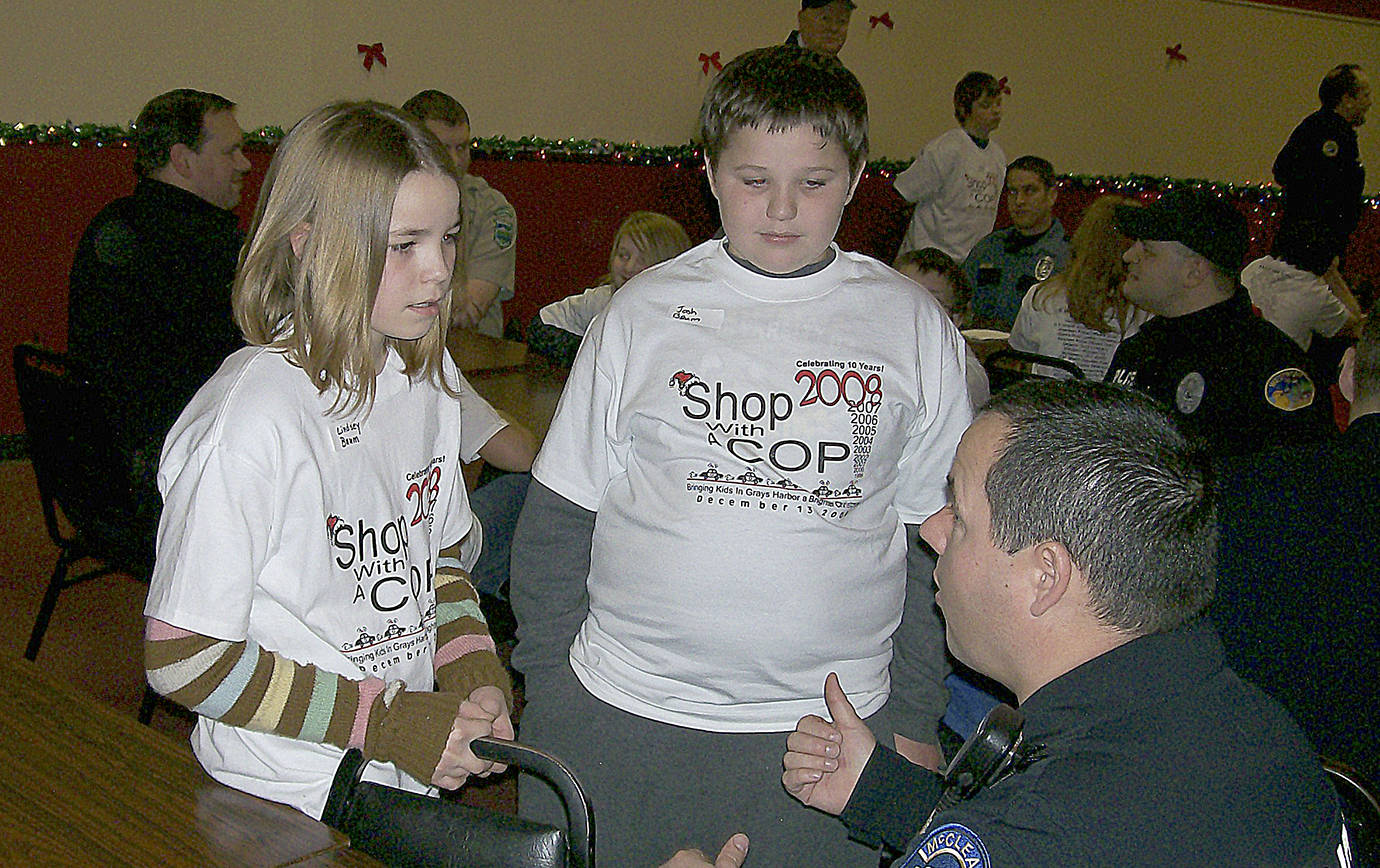 COURTESY LANE YOUMANS                                Lindsey Baum and her brother, Josh, speak with then McCleary Police officer John Graham at the Shop with a Cop event in December 2008. A little more than 6 months later she disappeared blocks from her home in McCleary.