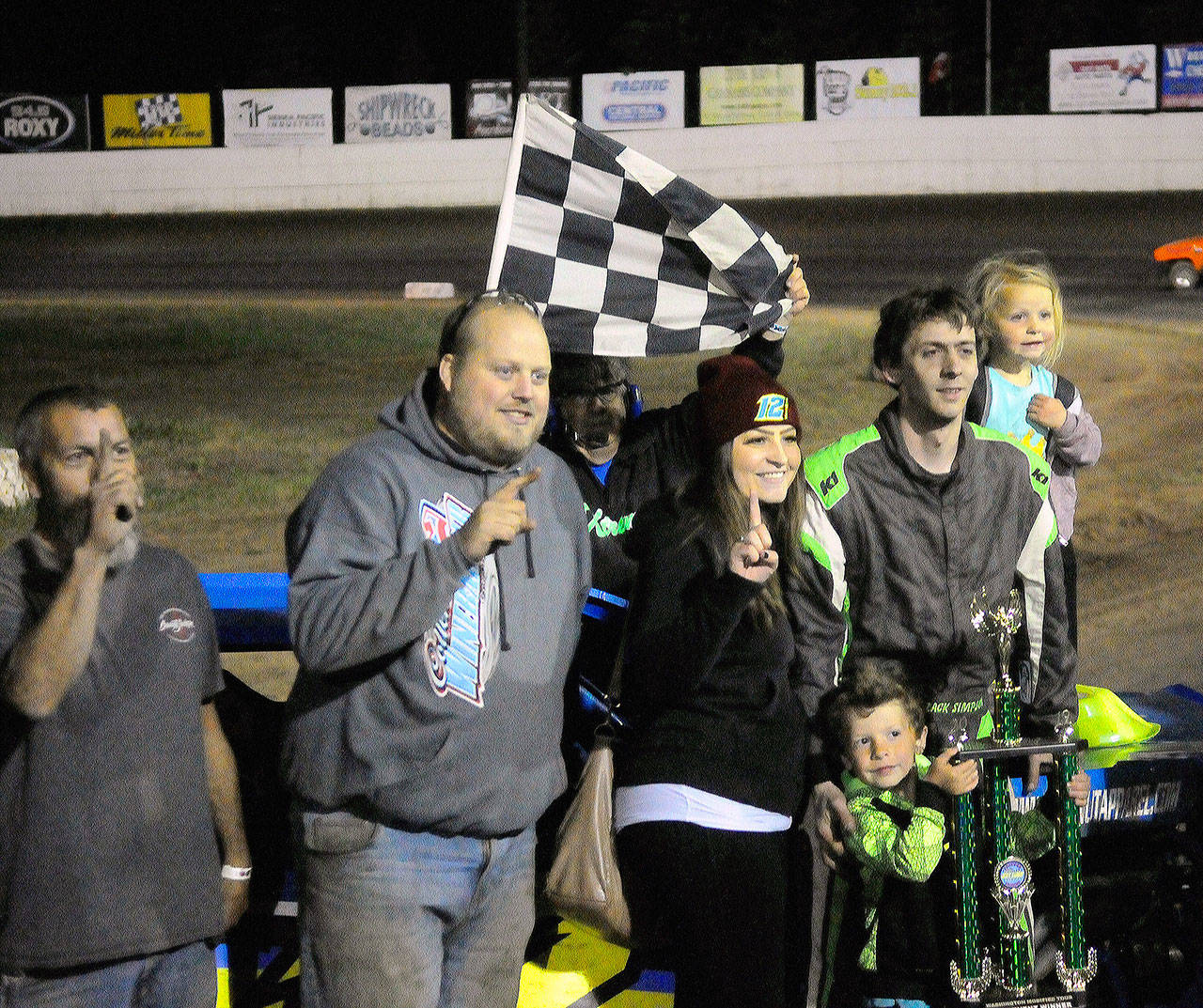 Driver Zack Simpson, second from right, regularly brings his wife and kids to the track with him on race day. From left: pit crew members Coal Canada and Tyson Henson stand next to Dallas Simpson (wife), Carter Simpson (son), Zack Simpson and Danika Simpson (daughter). (Hasani Grayson | Grays Harbor News Group)
