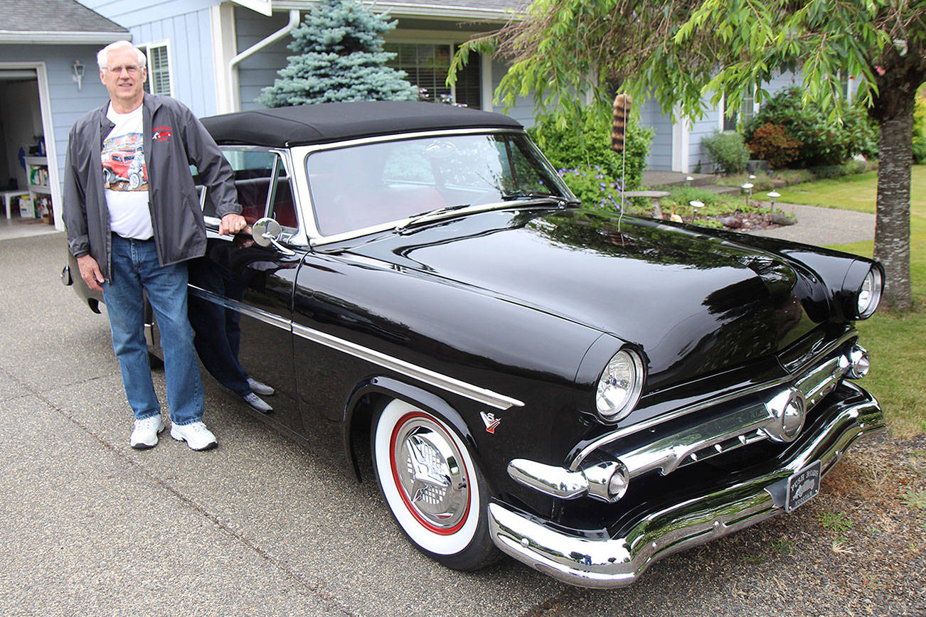 Denny Foster stands Monday, July 1, next to his 1954 Ford Sunliner, which he restored, at his Montesano home. Foster will enter the car in the Historic Montesano Car Show, which is 8 a.m. to 3 p.m. July 20 in Monte. (Michael Lang | Grays Harbor News Group)