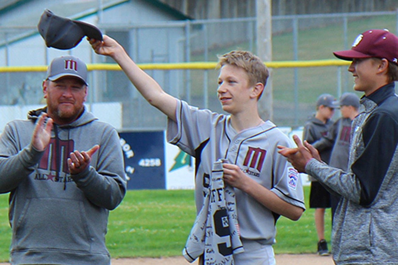 John Griffin (center) tips his cap during a ceremony in his honor July 3 at Nelson Field in Montesano. Griffin was told he’d won Little League Baseball’s 2019 Good Sport award during the ceremony. (Michael Lang | Grays Harbor News Group)