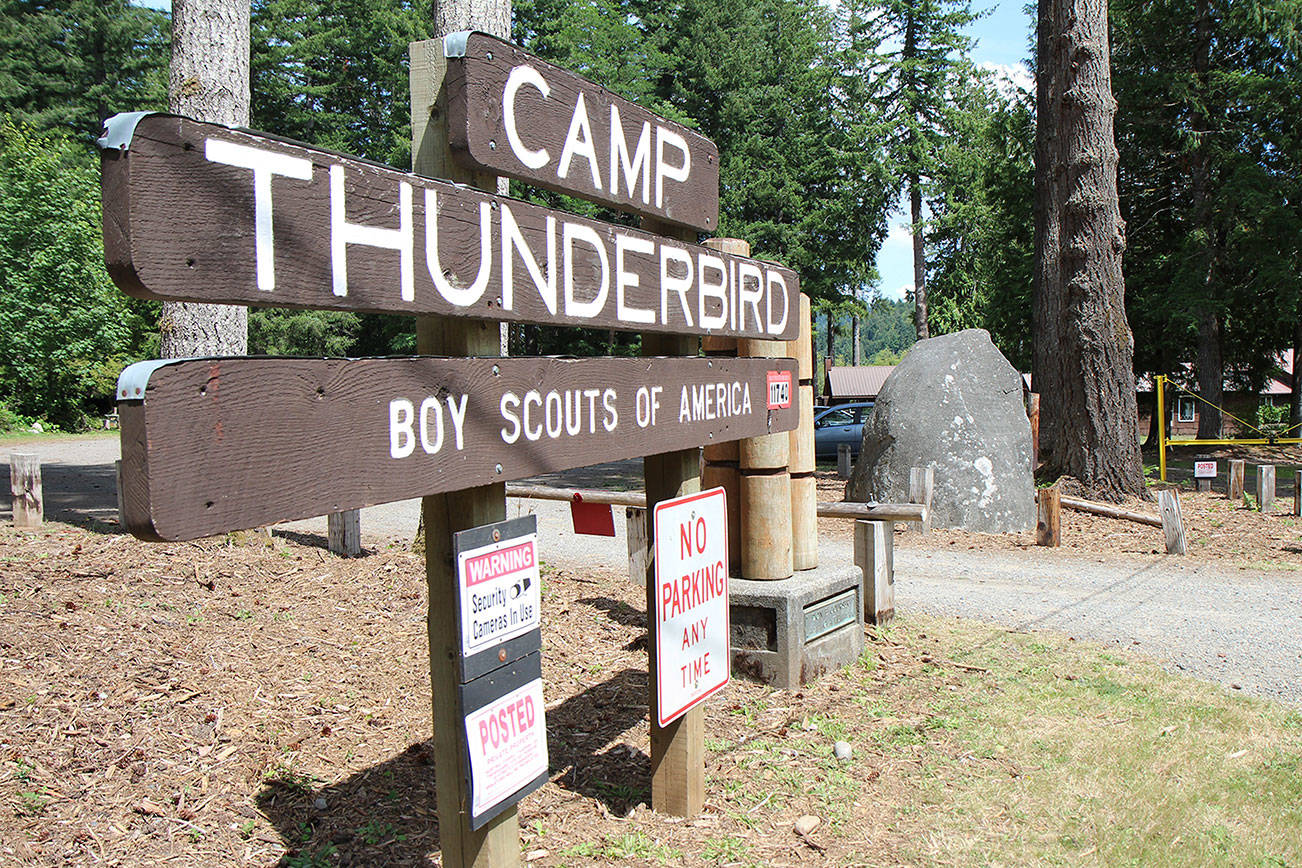 The Boy Scouts of America’s Camp Thunderbird at Summit Lake in Thurston County has played host to Pioneer Rock since the 1990s. Two area men hope to move the 29-ton granite rock — seen Wednesday, July 24, 2019, to the right of the sign — to the rest area east of Elma. (Michael Lang | Grays Harbor News Group)