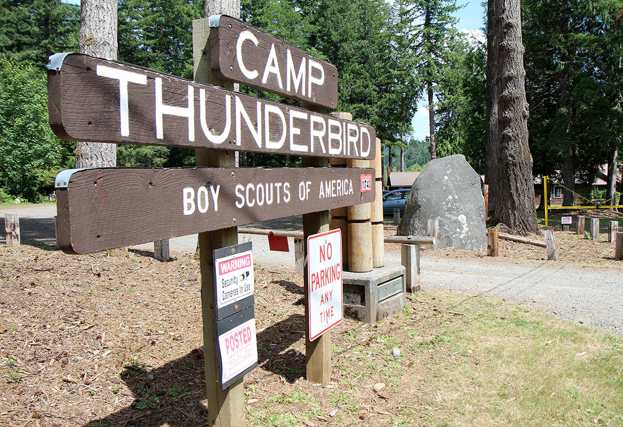 Photos by Michael Lang | Grays Harbor News Group                                The Boy Scouts of America’s Camp Thunderbird at Summit Lake in Thurston County has played host to Pioneer Rock since the 1990s. Two area men hope to move the 29-ton granite rock — seen July 24, to the right of the sign — to the rest area east of Elma.
