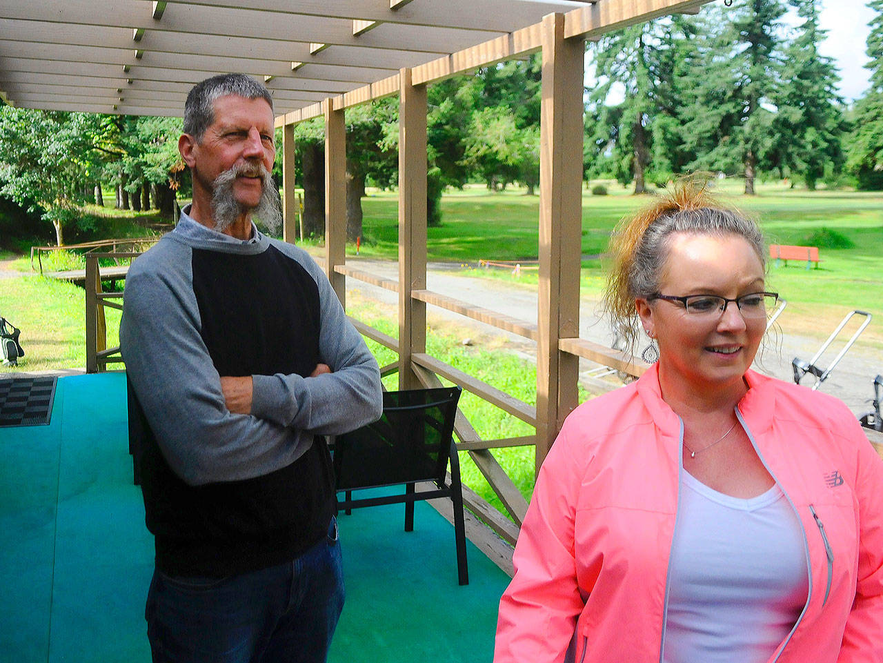 Rich and Denise Walker survey Oaksridge Golf Course as golfers start their round on July 27. (Hasani Grayson | Grays Harbor News Group)