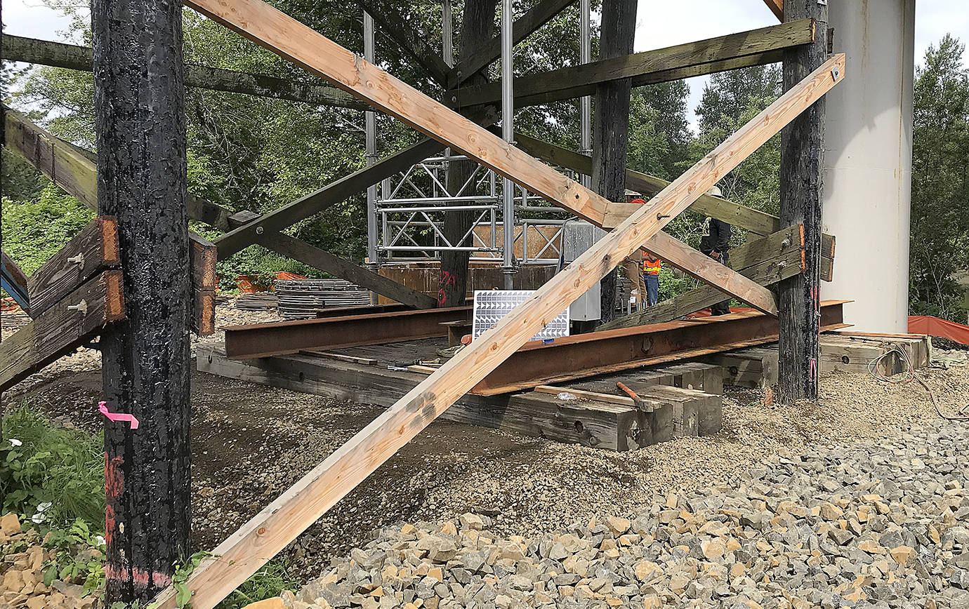 COURTESY DEPARTMENT OF TRANSPORTATION                                Crews from Rognlin’s Inc. shore up the State Route 107 Chehalis River bridge south of Montesano. The roadway, closed Tuesday morning after construction crews found the timber bridge support pilings on the south approach had settled up to six inches, is on track to reopen at 8 a.m. Friday.