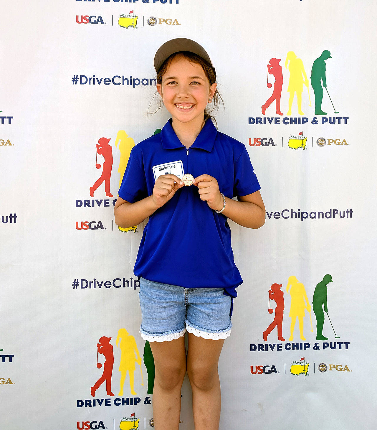 Grays Harbor Junior Golf’s Makenzie Hart holds up her bronze medal after taking third in the Drive, Chip & Putt competition on Aug. 5. Hart’s third-place finish was helped by her sinking a 6-foot putt. (Submitted Photo)