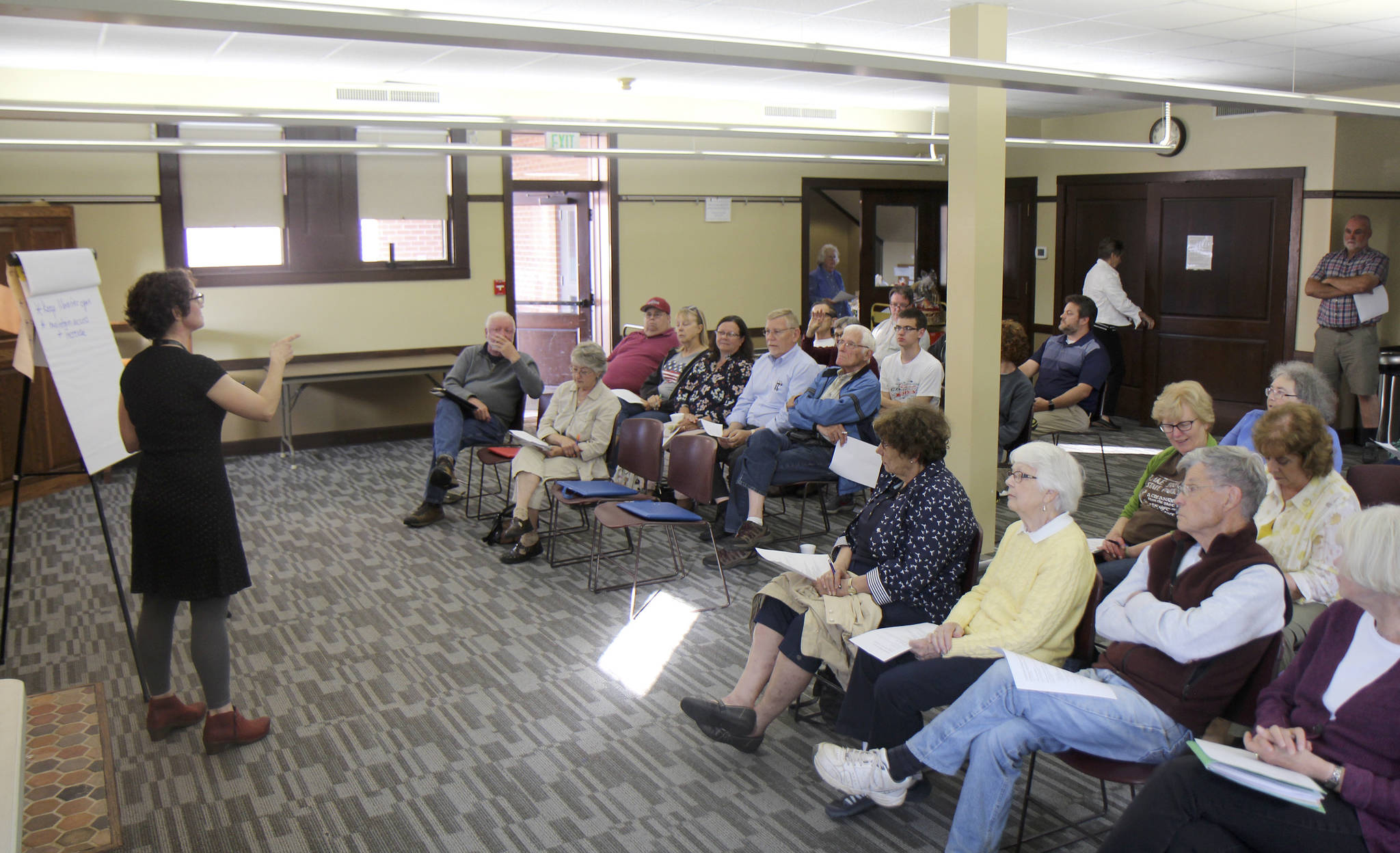 Photos by Michael Lang | Grays Harbor News Group                                Sarah Ogden (left), district manager for innovation and user experience at Timberland Regional Library, calls on a member of the audience during a public meeting Aug. 21 at the branch in Hoquiam.