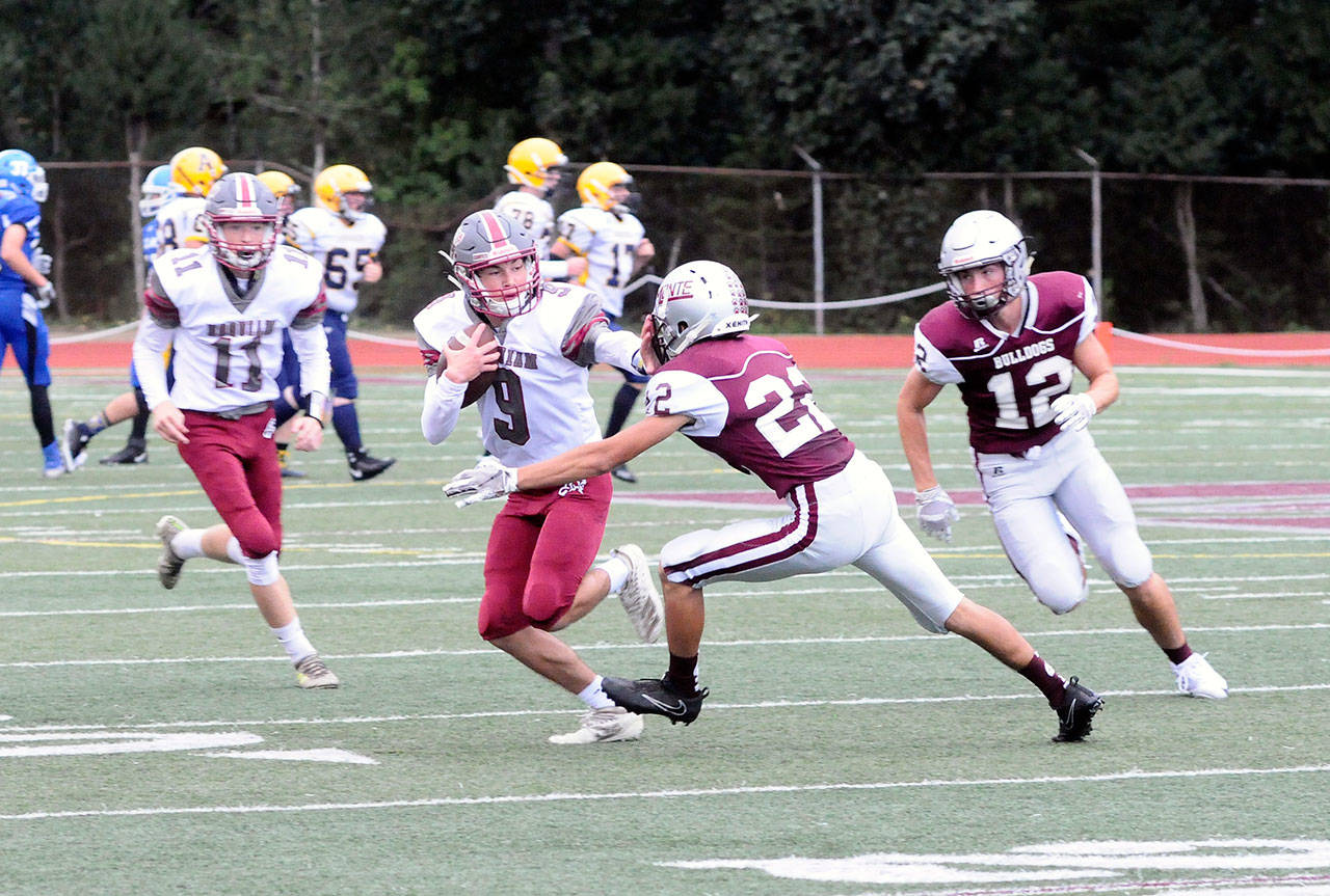 Hoquiam’s Dane McMillan fights off a tackle by Montesano defender Alex Mesquita during the Jamboree at Montesano High School on Friday. (Hasani Grayson | Grays Harbor News Group)