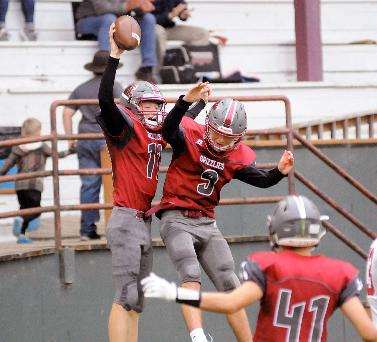 Hoquiam wide receiver Cameron Bumstead, left, celebrates with teammate Dane McMillan after catching a 36-yard touchdown pass from Matt Brown during Hoquiam’s 48-12 victory over Castle Rock on Friday at Olympic Stadium. (Ryan Sparks | Grays Harbor News Group)