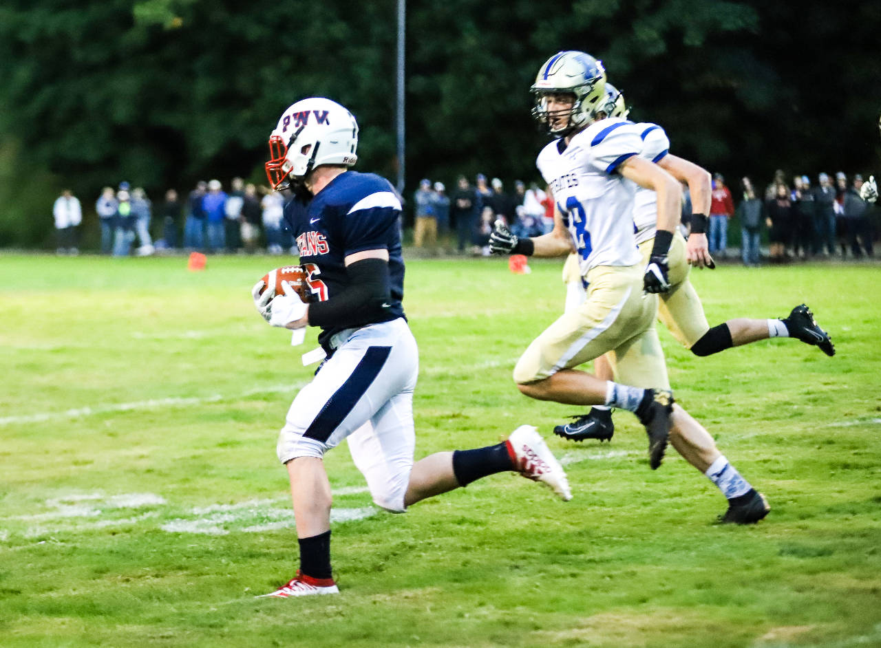 PWV running back Peter Hamilton, left, carries the football against Adna on Friday in Menlo. (Photo by Larry Bale)