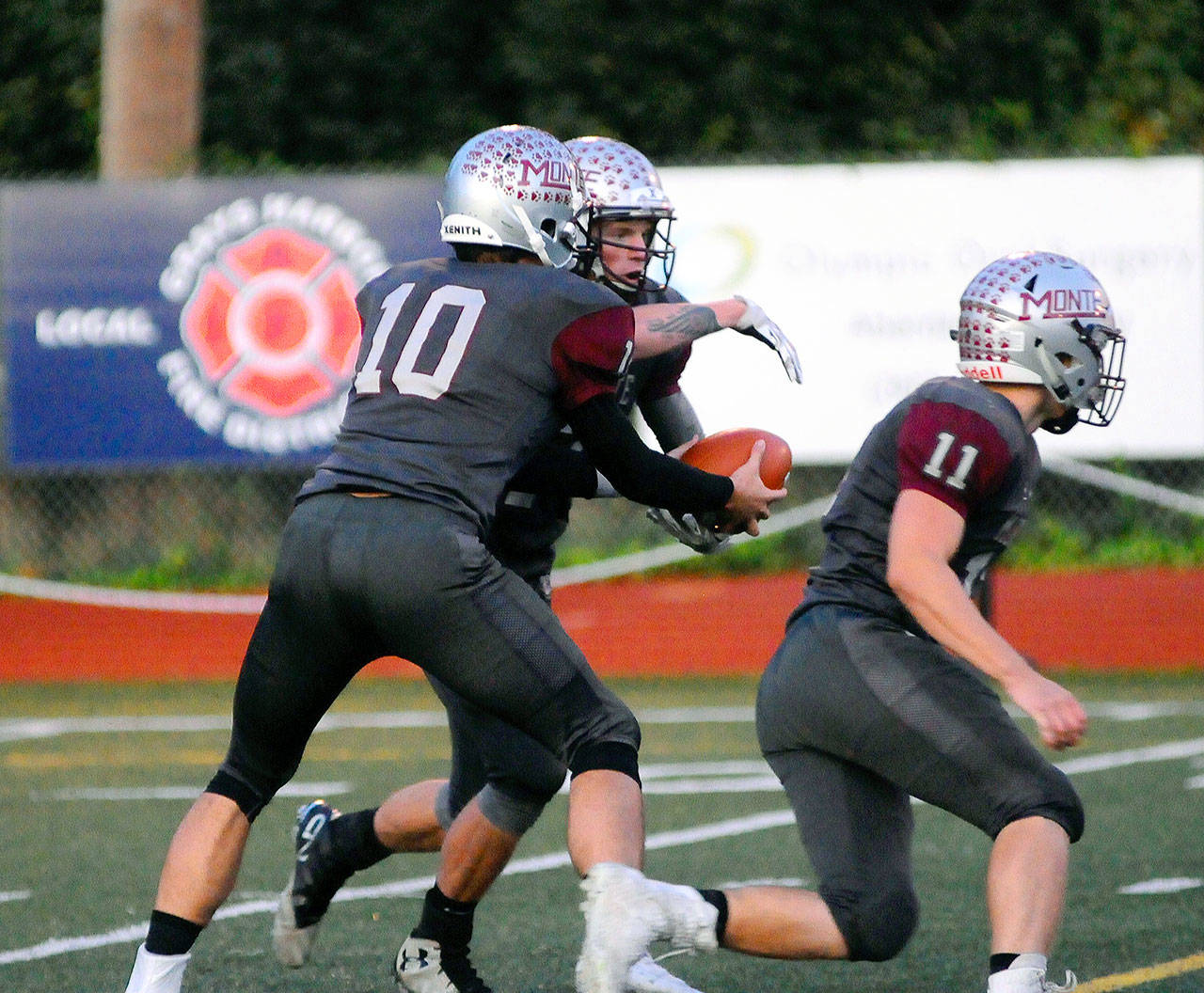 Montesano quarterback Trace Ridgway (10) hands the ball off to Aydan Darst in the first quarter of a game against Port Angeles on Friday at Jack Rottle Field in Montesano. (Hasani Grayson | Grays Harbor News Group)