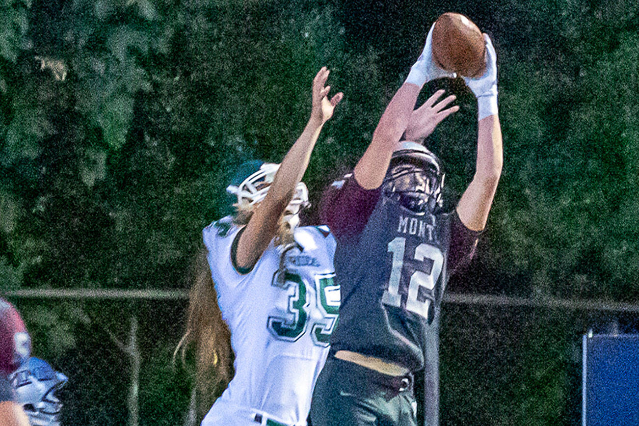 Montesano’s Sam Winter (12) intercepts a pass against Port Angeles recevier Derek Bowechop during the Bulldogs’ 70-12 rout of the Roughriders on Friday at Jack Rottle Field in Montesano. (Photo by Shawn Donnelly)