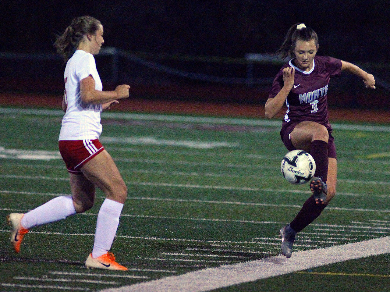 Montesano’s Sierra Birdsall controls a pass near the sidelines while defended by Hoquiam’s Emily Daniels in the first half of a match at Jack Rottle Field in Montesano. (Hasani Grayson | Grays Harbor News Group)