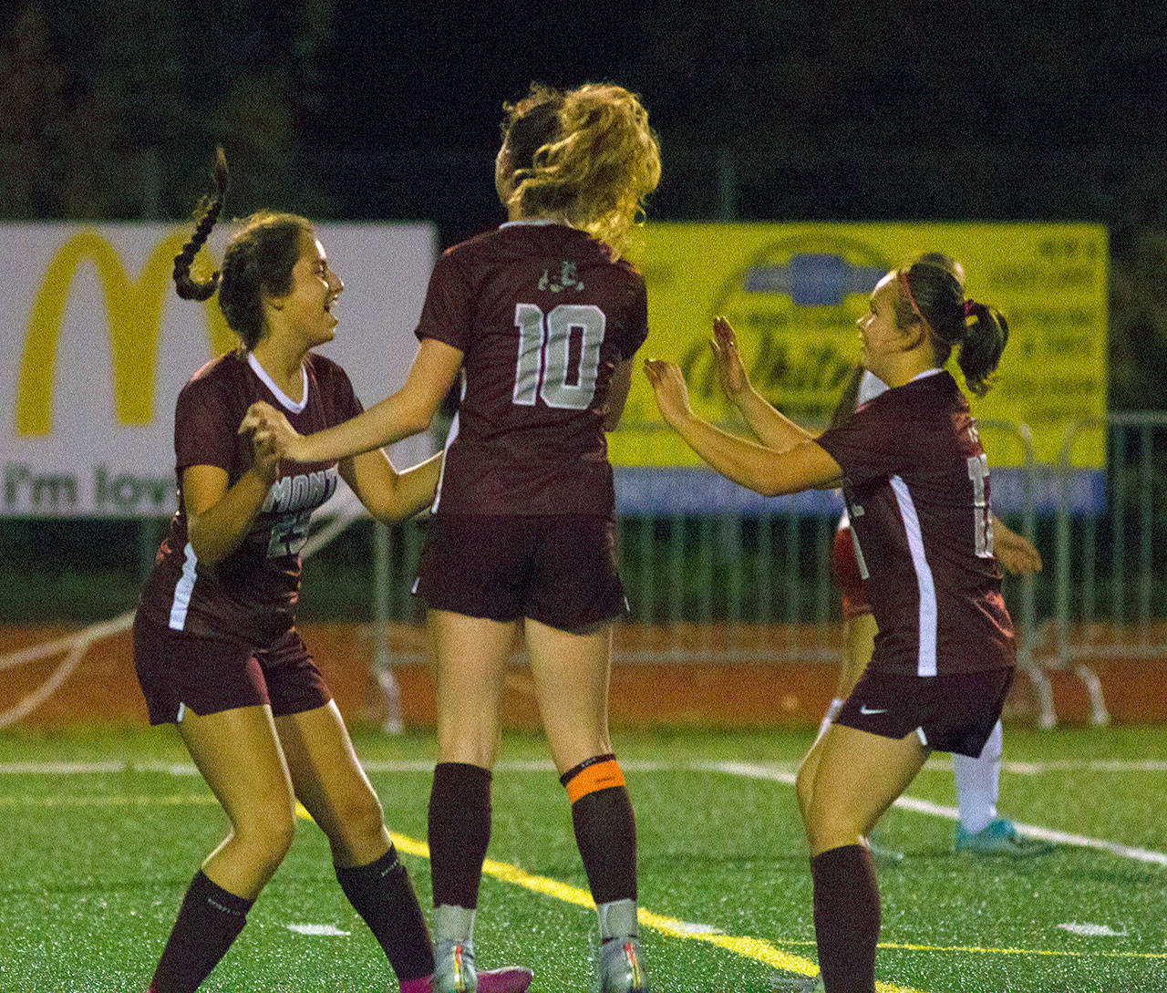 Montesano’s Elleah Jones, left, celebrates with Brooke Streeter, middle, and Izabel Cope after scoring a goal in the 25th minute of the first half of a match against Hoquiam. (Hasani Grayson | Grays Harbor News Group)