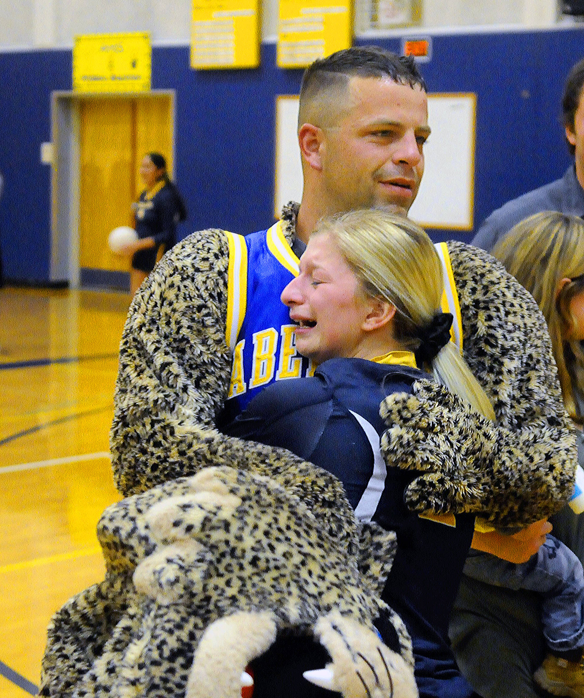 Photos by Hasani Grayson | Grays Harbor News Group                                Army Sgt. Bradley Heden hugs sister-in-law Abby Baumgardner after surprising her by taking off the Bobcat mascot head before a match on Oct. 9.