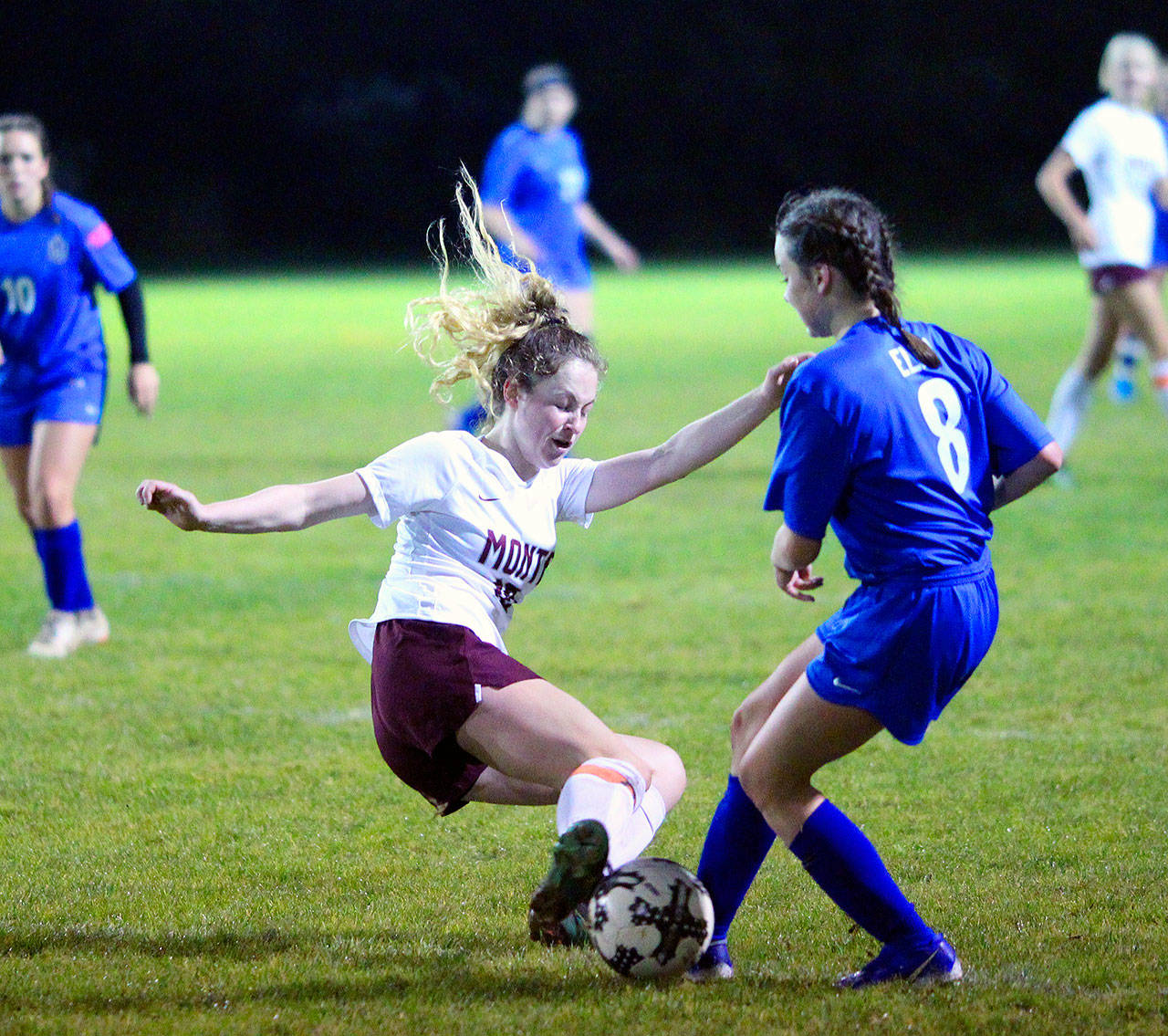Montesano’s Brooke Streeter executes a slide tackle to get the ball away from Elma’s Janessa Sample in the second half of a match on Tuesday in Elma. (Hasani Grayson | Grays Harbor News Group)