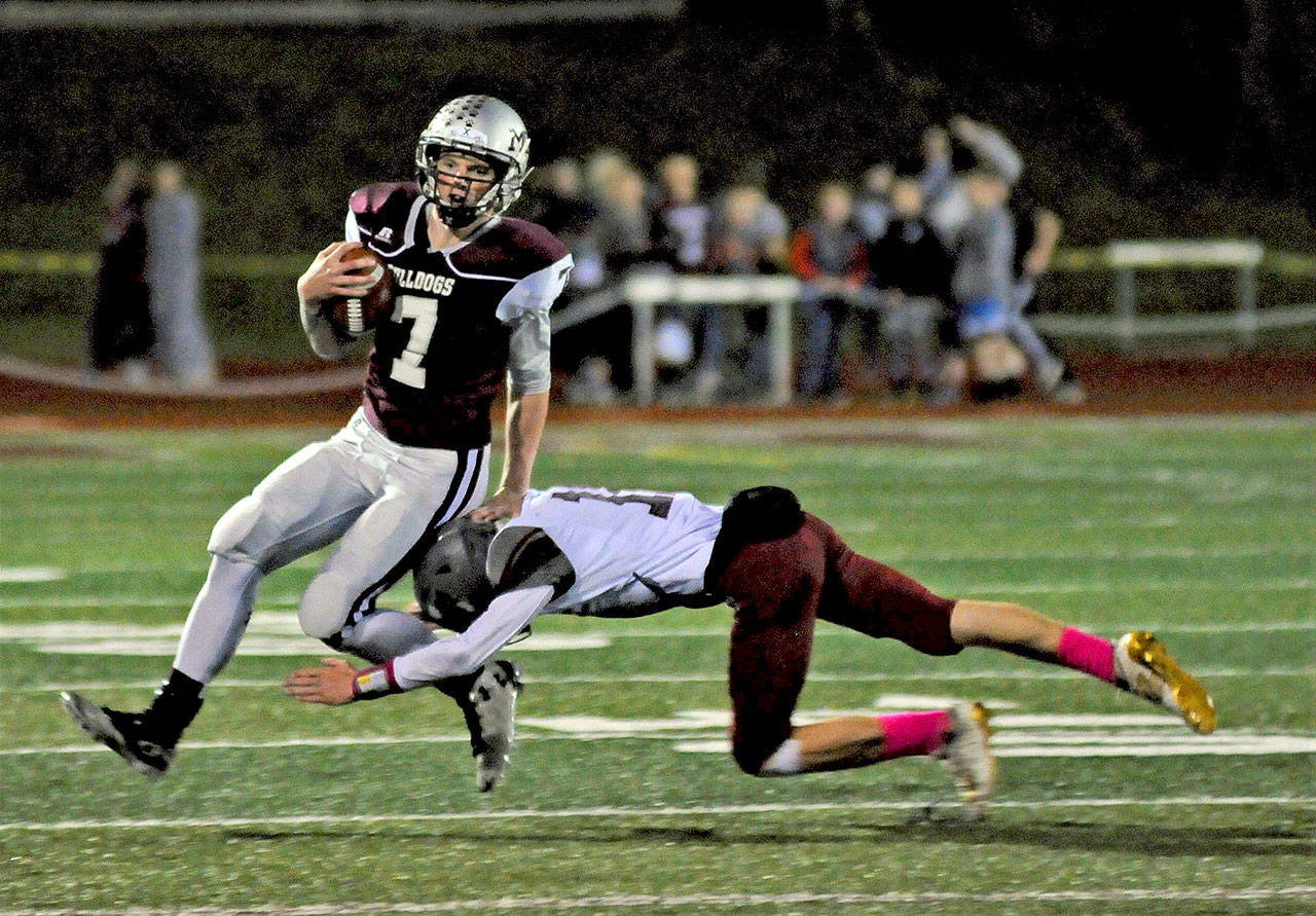 Montesano running back Aydan Darst runs toward the sideline as Hoquiam’s Cameron Bumstead makes the tackle during Montesano’s 48-0 win on Friday at Jack Rottle Field. (Hasani Grayson | Grays Harbor News Group)