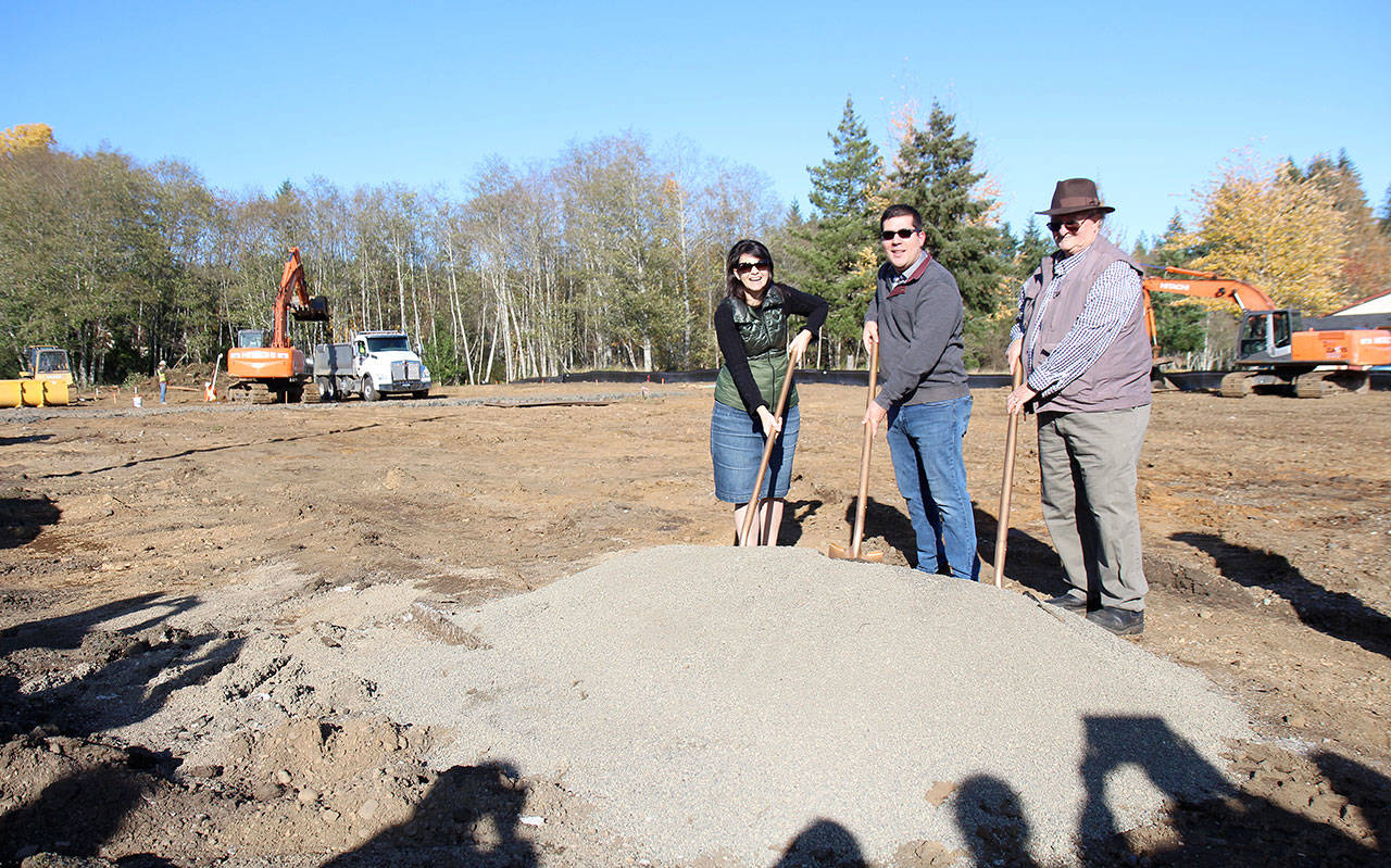 Michael Lang | Grays Harbor News Group                                Dave Pearsall (from right), McCleary City Councilman Brycen Huff and McCleary Mayor Brenda Orffer take part in a ceremonial groundbreaking Friday, Oct. 25, in McCleary for what will be a Dollar General store. Pearsall’s family used to own the land that was sold to the company.