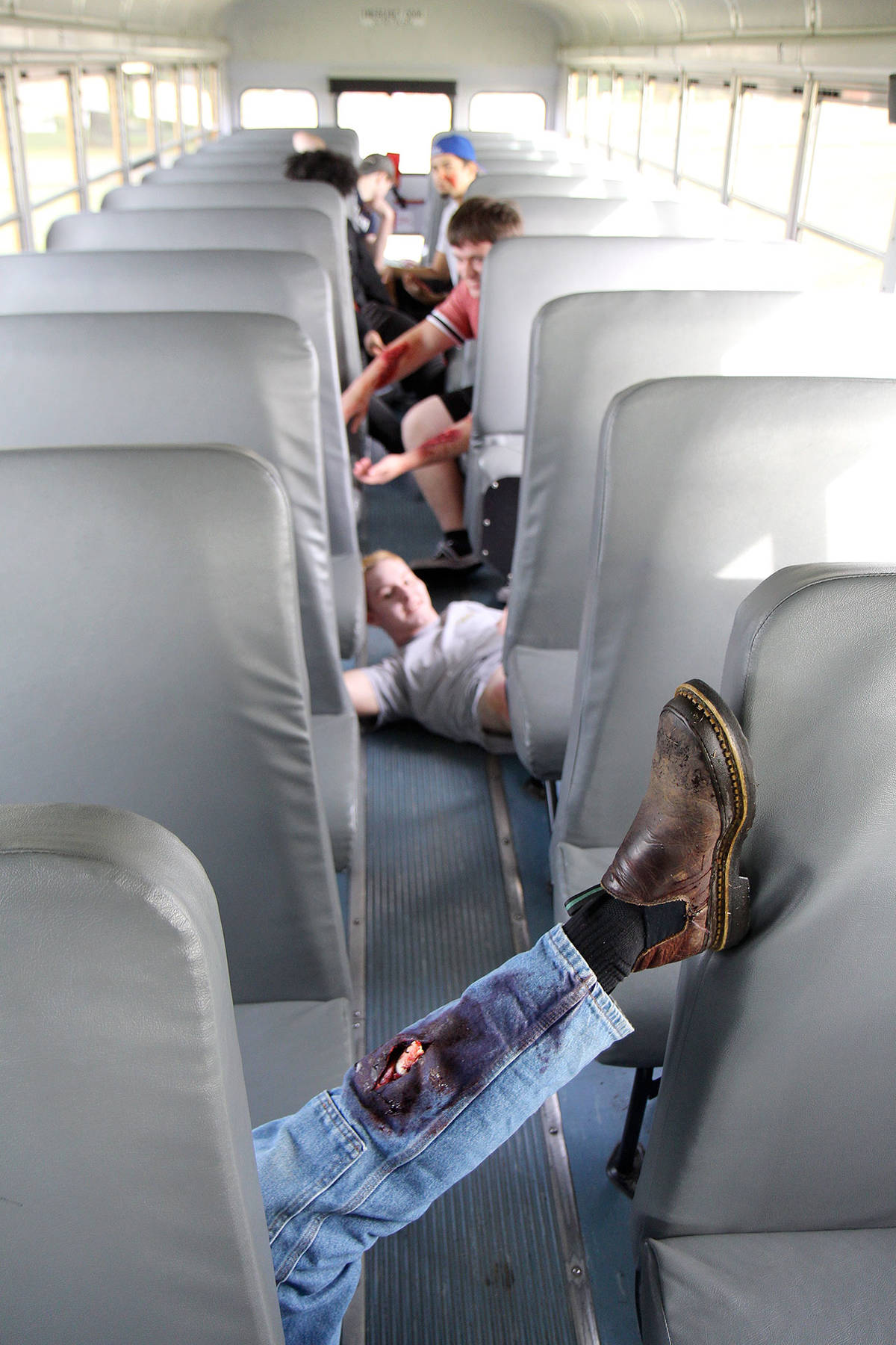 A group of Elma High School seniors show off their fake injuries while taking part in an emergency preparedness drill Wednesday, Oct. 23, in Elma. The students were given makeup to make them look as if they’d been riding on a bus that rolled over. (Michael Lang | Grays Harbor News Group)