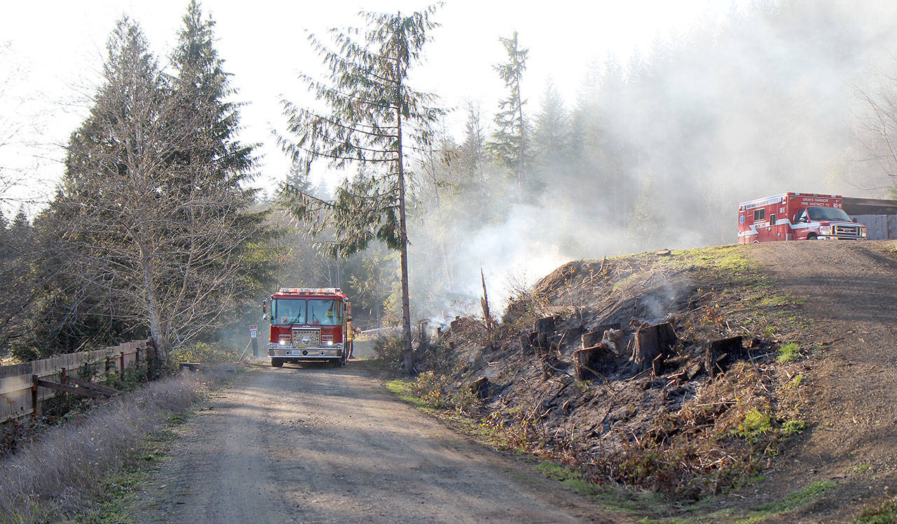 Photos by Michael Lang | Grays Harbor News Group                                Above, crews from Grays Harbor Fire District 2 fight a brush fire Tuesday afternoon, Oct. 29, 2019, east of Montesano. By 10:30 a.m. Wednesday, the fire was 100 percent contained. Crews from four fire agencies were called in to help fight the blaze. Below, A fire smolders on a hillside while crews from Grays Harbor Fire District 2 try to knock it down Tuesday afternoon, Oct. 29, 2019, east of Montesano. By 10:30 a.m. Wednesday, the fire was 100 percent contained. Crews from four East County fire agencies were called in to help fight the blaze.