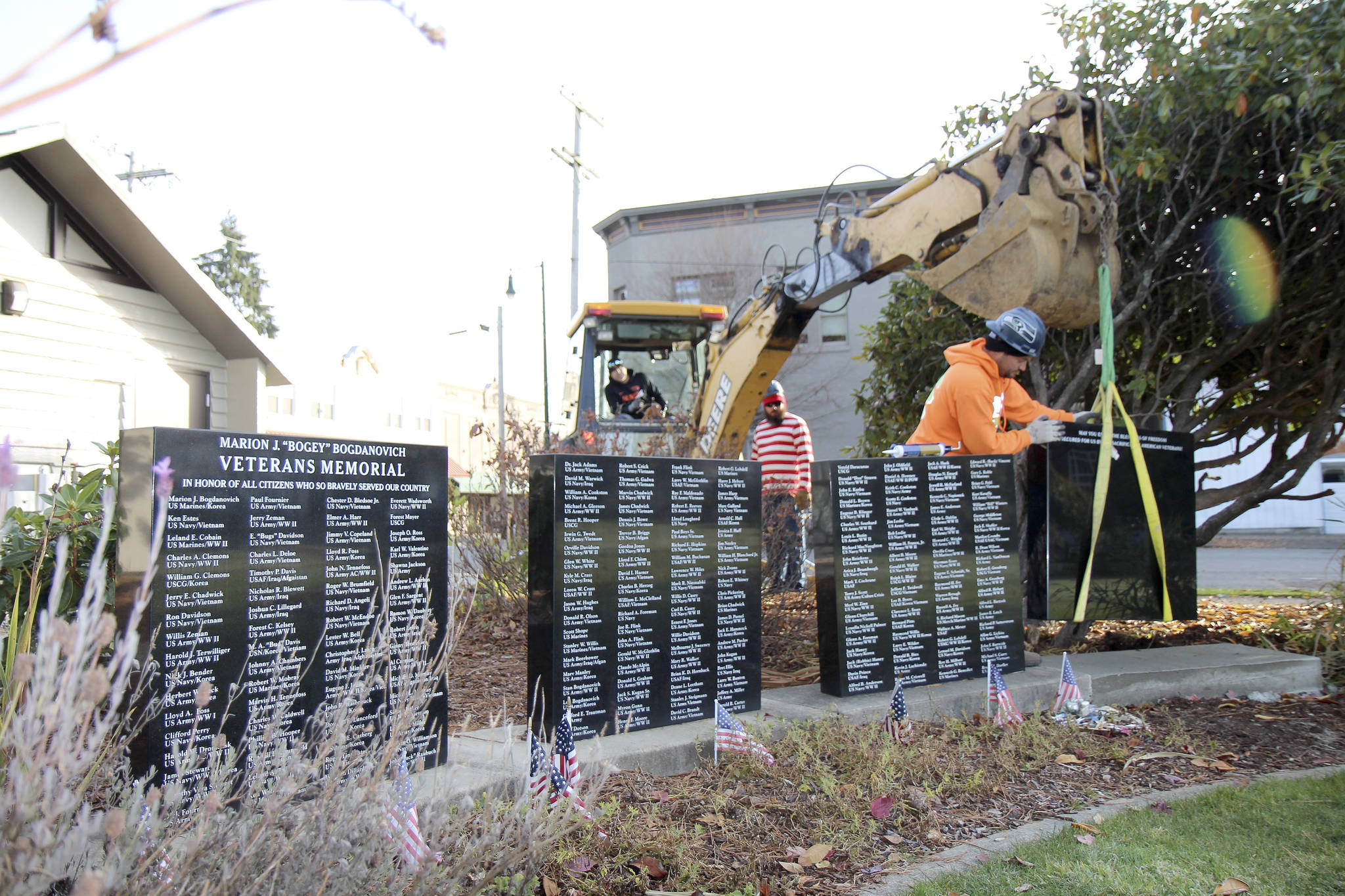 Michael Lang | Grays Harbor News Group                                City of Montesano and Aberdeen Cemetery Association personnel add a fourth marble monument to the Marion J. “Bogey” Bogdanovich Veterans Honor Wall on Thursday, Oct. 31, 2019, at Fleet Park in Montesano.