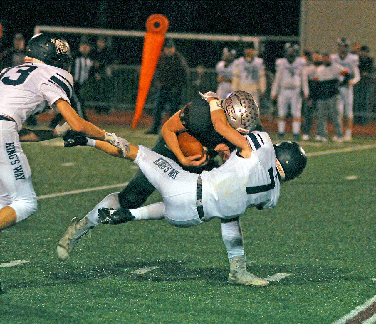 Montesano running back Brent Hollatz, left, bowls over King’s Way Christian safety Bryson Metz during the first half of the Bulldogs’ 58-14 victory in a 1A crossover game on Friday in Montesano. (Ryan Sparks | Grays Harbor News Group)