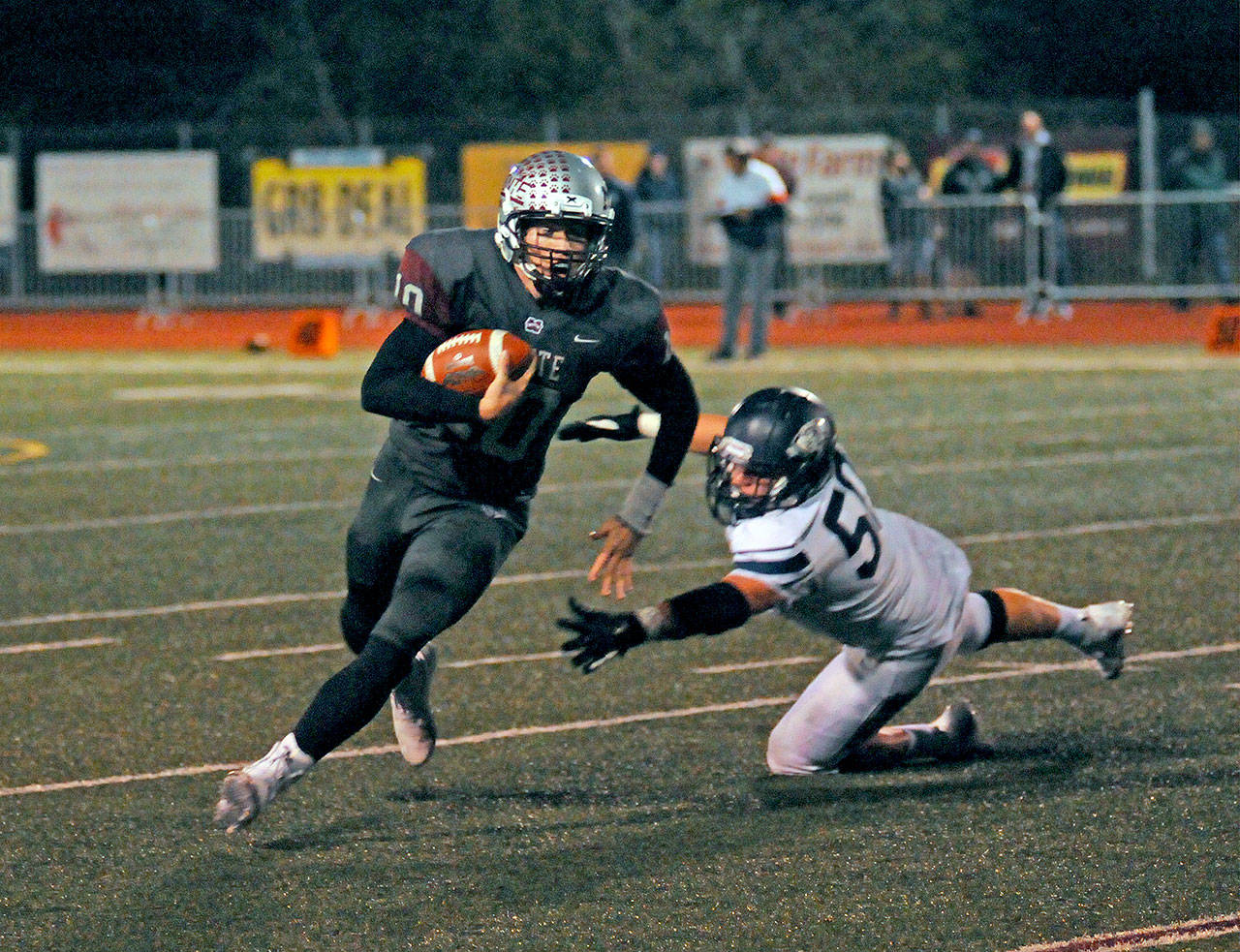 Montesano quarterback Trace Ridgway, left, avoids the tackle of King’s Way Christian linebacker Bailey Meek during Friday’s 1A State crossover game at Jack Rottle Field in Montesano. (Ryan Sparks | Grays Harbor News Group)