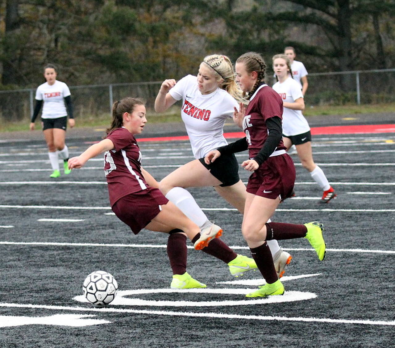 Montesano’s Jaiden King, left, and Cassadie Golding, right, defend against Tenino’s Morgan Miner during Saturday’s district title game at Tenino High School. (Photo by Shawn Donnelly)