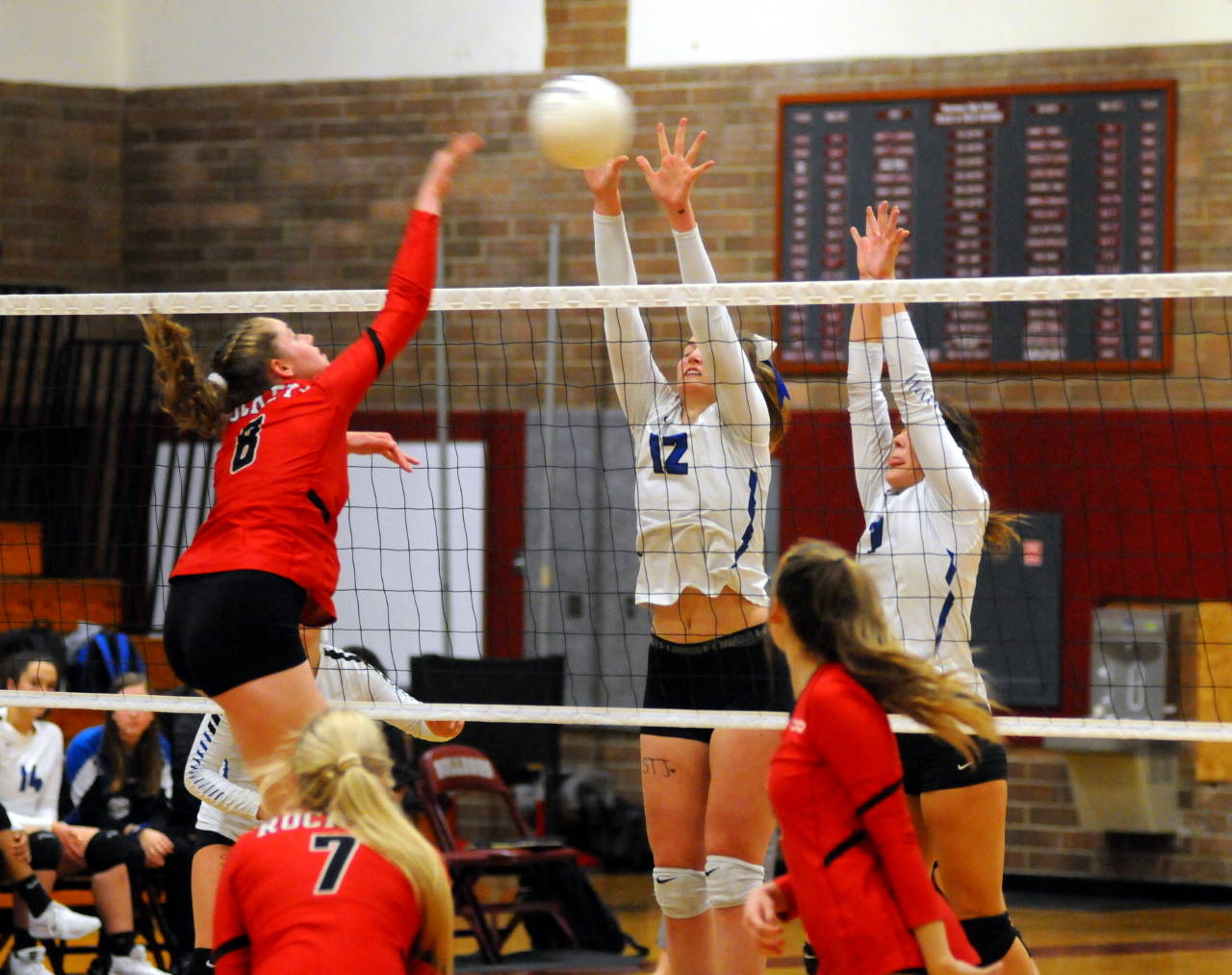 Elma’s Jalyn Sackrider (12) and Ella Moore defend a kill attempt from Castle Rock’s Jordyn Burks during Wednesday’s district playoff game in Montesano. (Ryan Sparks | Grays Harbor News Group)