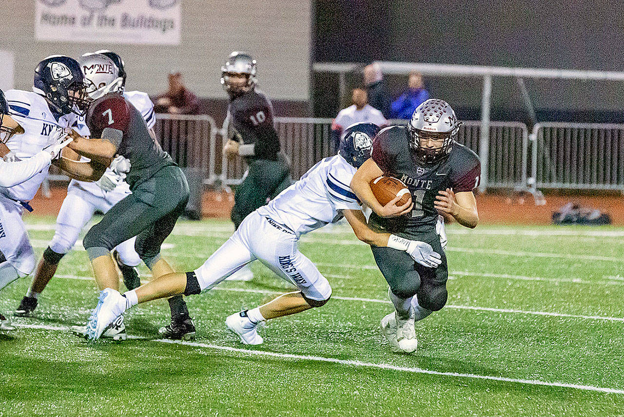 Montesano’s Brent Hollatz, right, carries the football against King’s Way Christian on Nov. 8. (Photo by Shawn Donnelly)