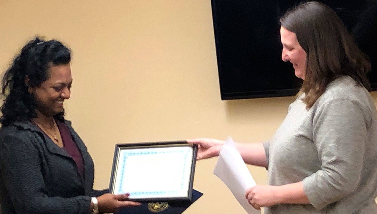 Photo courtesy Helen Hepp                                Montesano Mayor Vini Samuel (left) receives the 24th Margaret Downey community service award from Friends of the W.H. Abel Memorial Library president Megan Valentine, who also is a member of the Montesano City Council, on Nov. 26 at the library.